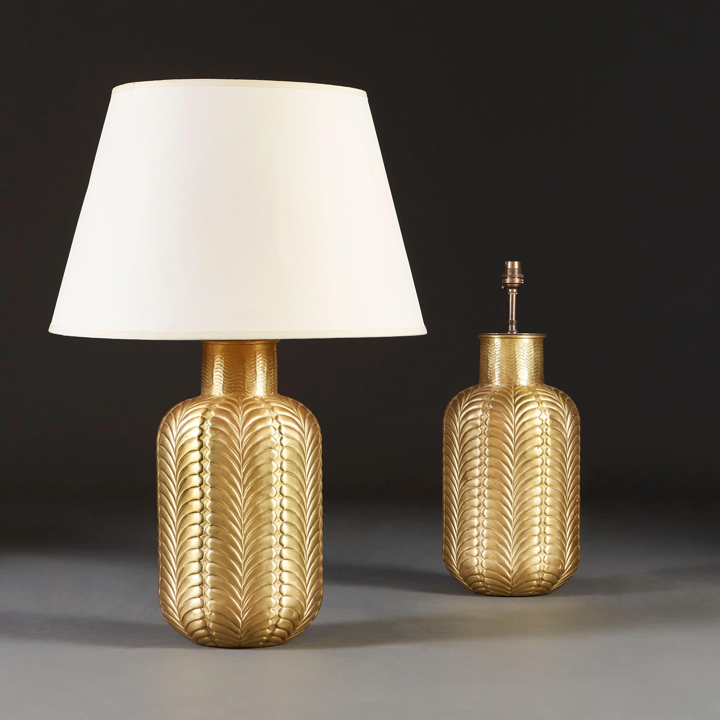 A pair of palm leaf pattern brass vases now mounted as lamps.

Currently wired for the UK.

Please note: Lampshades not included.