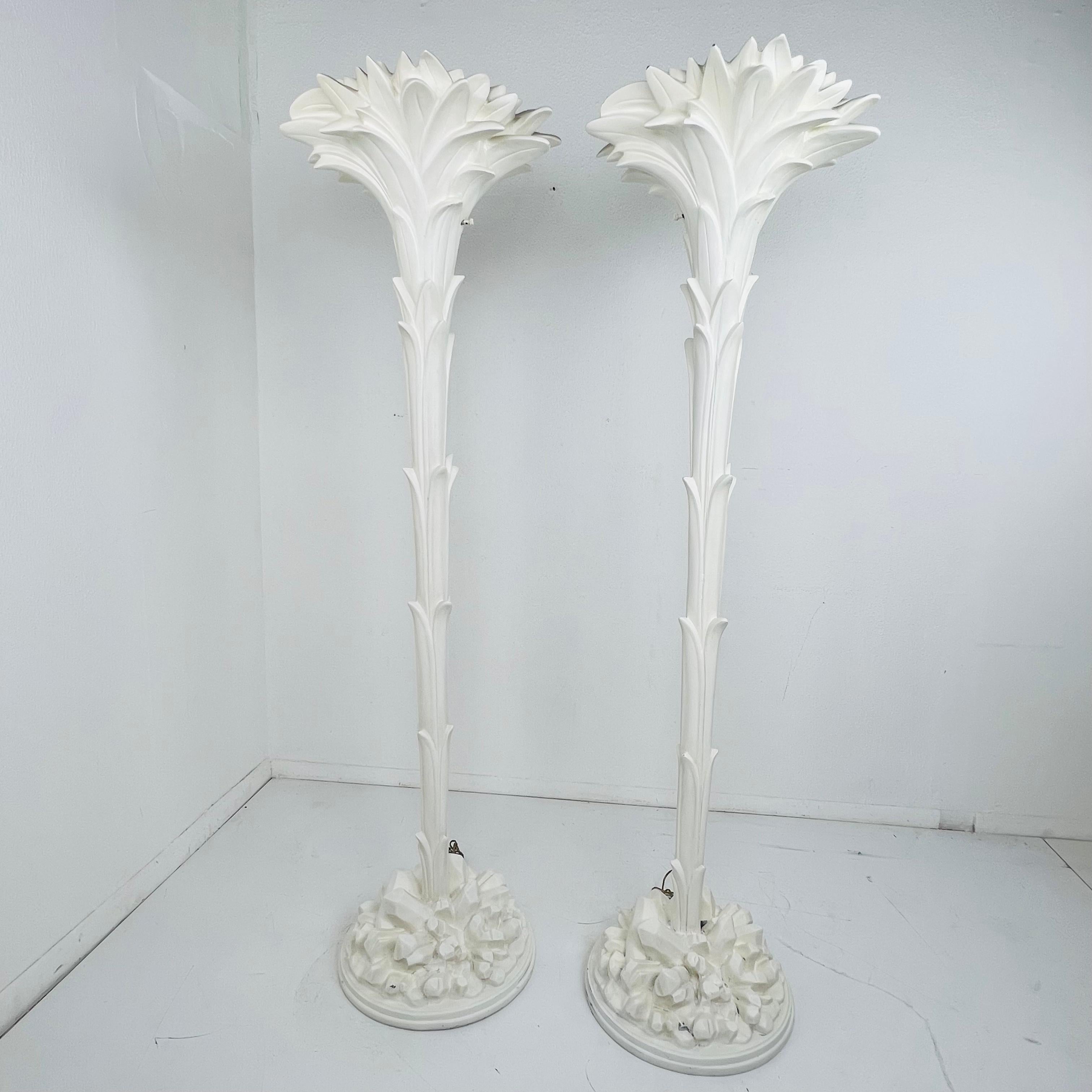 Stunning pair of 1970s palm leaf torchiere lamps in cast resin and white plaster, mounted on a white wooden base with styled crystals. Single light fitting with original switch. These Hollywood Regency style torchiere floor lamps are made after the