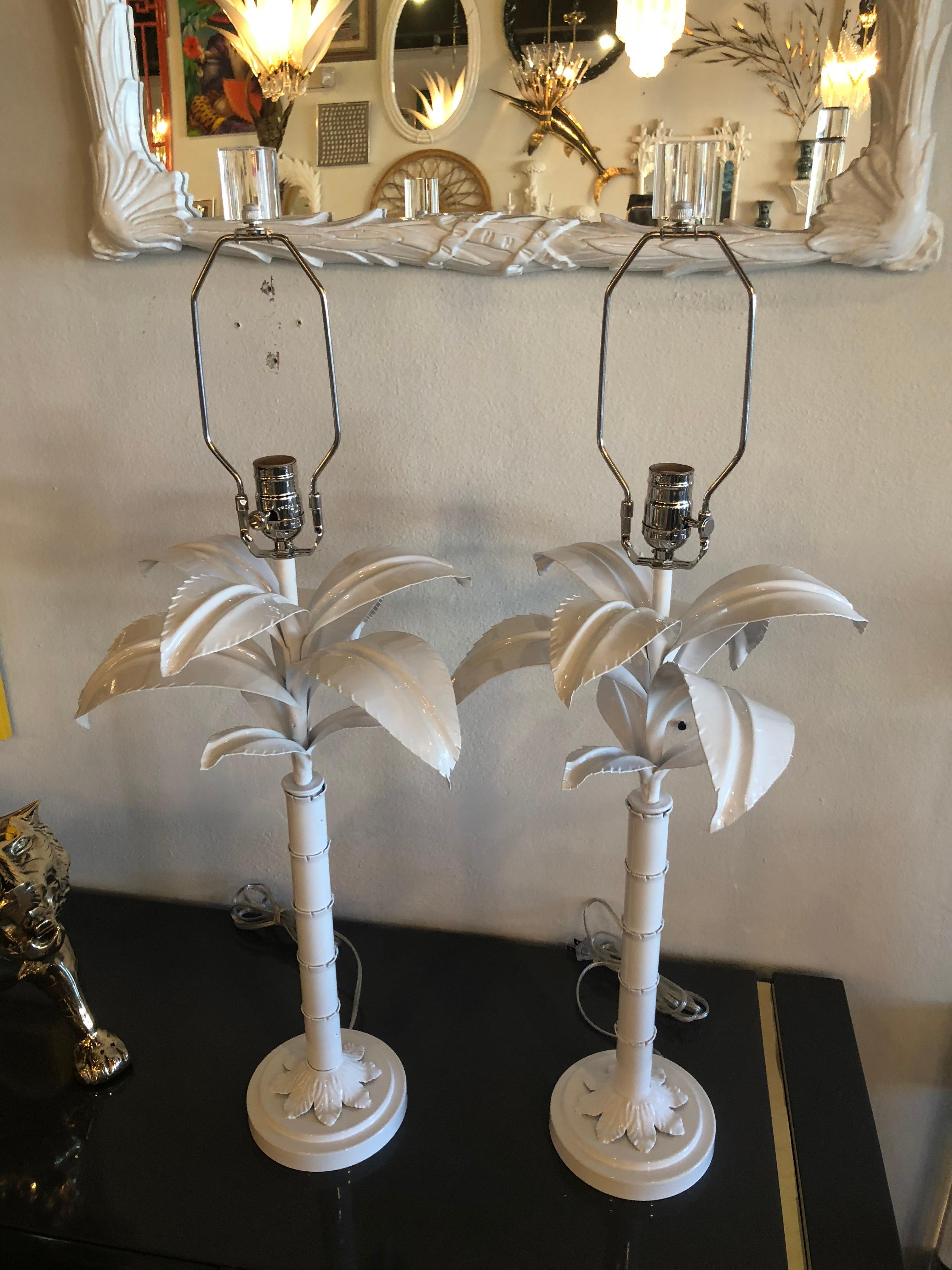 Vintage pair of Palm Tree frond leaf metal tole table lamps. These have been meticulously restored. Newly powder coated in a fresh white gloss, new chrome hardware, Lucite finials, professionally rewired.
25 tall to socket.