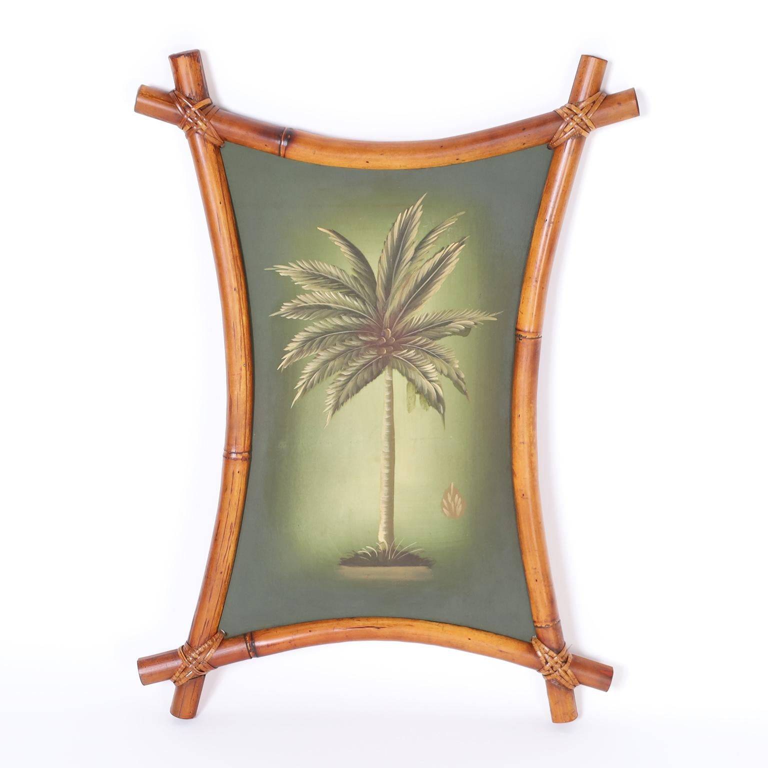 Pair of palm tree oil paintings on board presented in bent bamboo frames with reed wrapped corners.