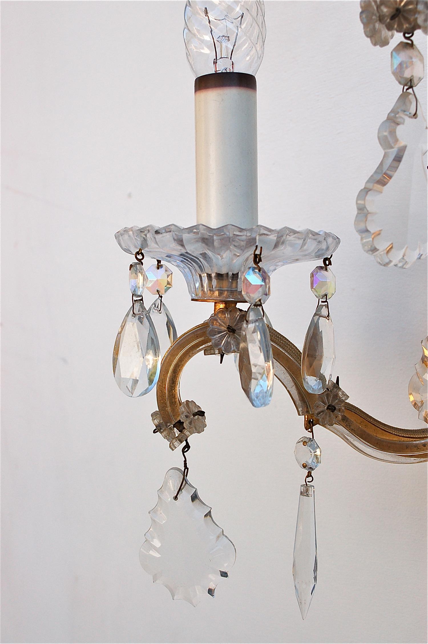 A pair of well preserved, quality two-arm wall sconces by manufacturer Palme & Walter (later Palwa). Both are decorated with crystal droplets and mounted on shapely, gold painted aluminium support. Each sconce has two arms with a classic scroll