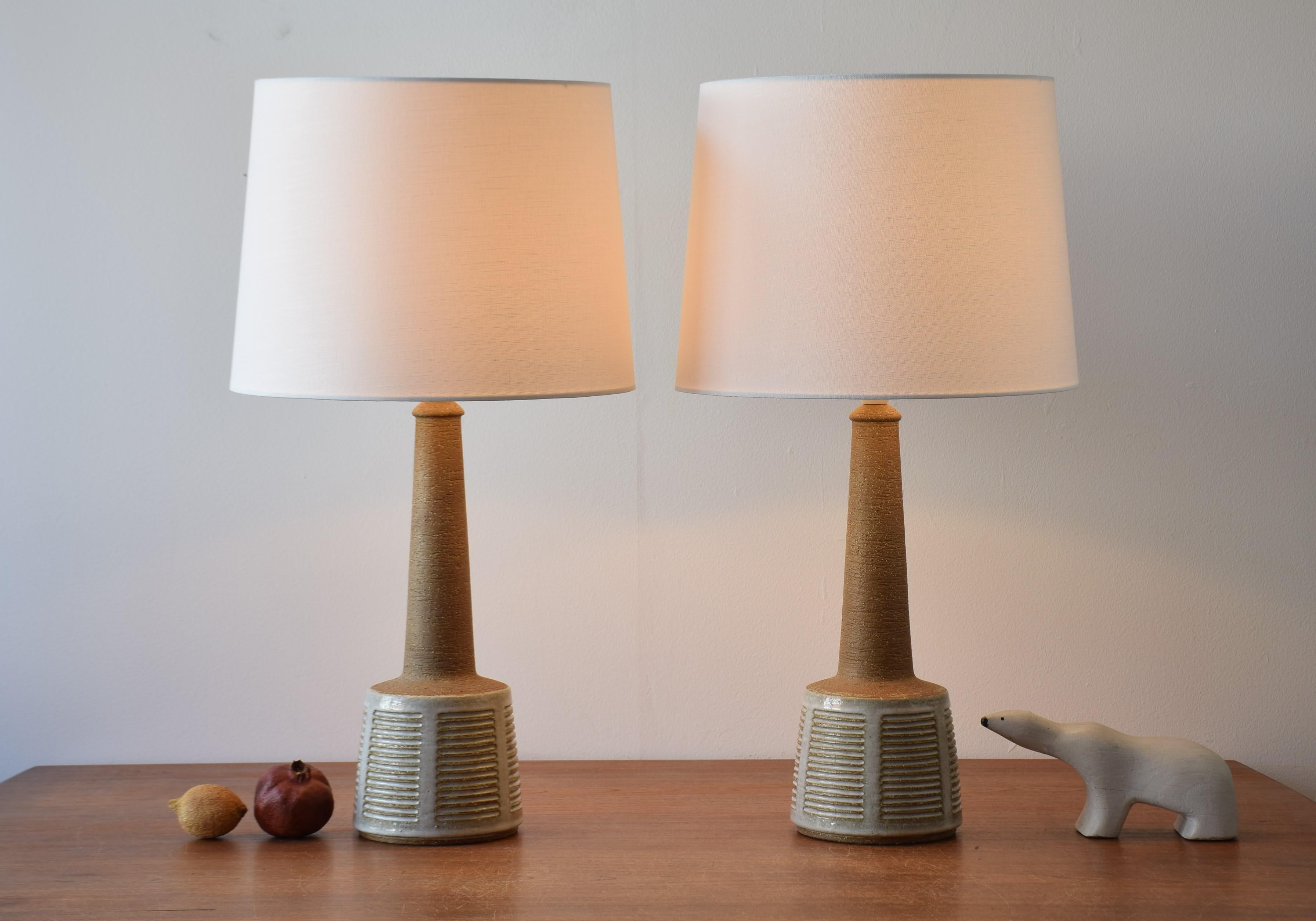 Pair of vintage Palshus Denmark tall ceramic lamps including new quality lampshades!

The lamps were made in cooperation with the Danish lamp manufacturer Le Klint and were designed by Esben Klint. They are manufactured circa 1960s. The lamps are