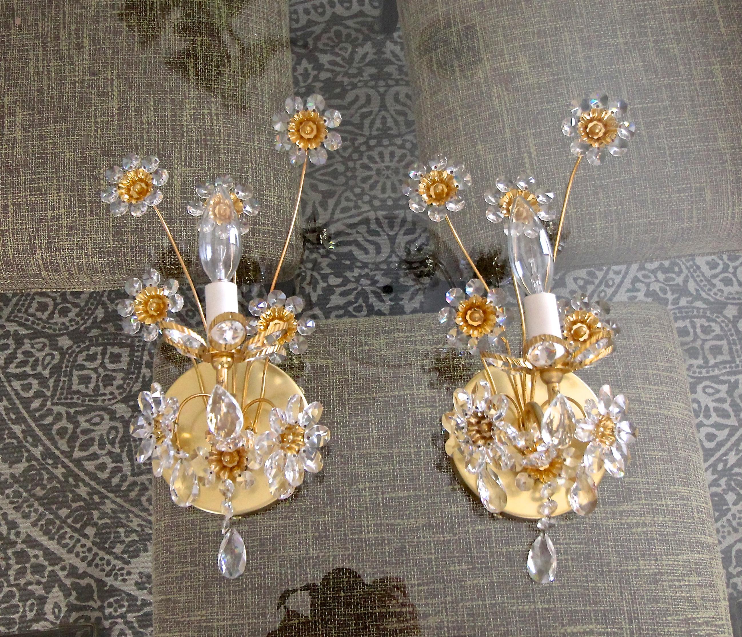 Pair crystal and gilt brass floral motif wall sconces by Palwa, Germany. Each sconces uses single candelabra base bulb. Newly wired with newer backplate for US installation. 
