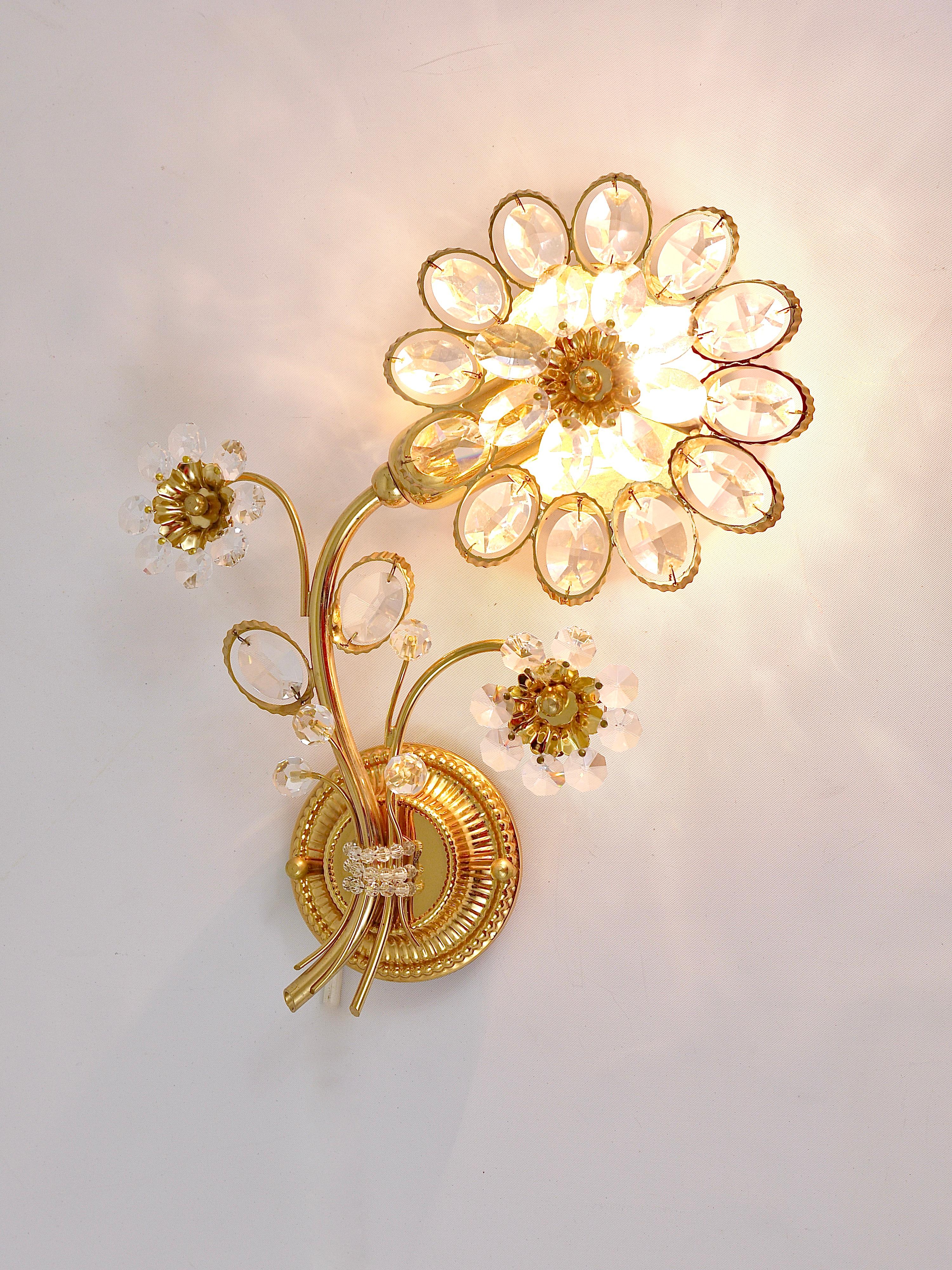 A pair of beautiful floral sconces, manufactured in the 1970s by Palwa, Germany. Made of gilt brass with crystal glass petals. In excellent condition.