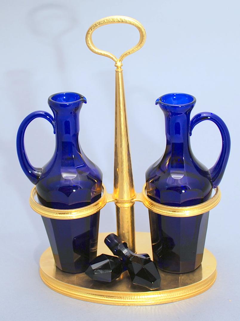 silver cruet set with blue glass