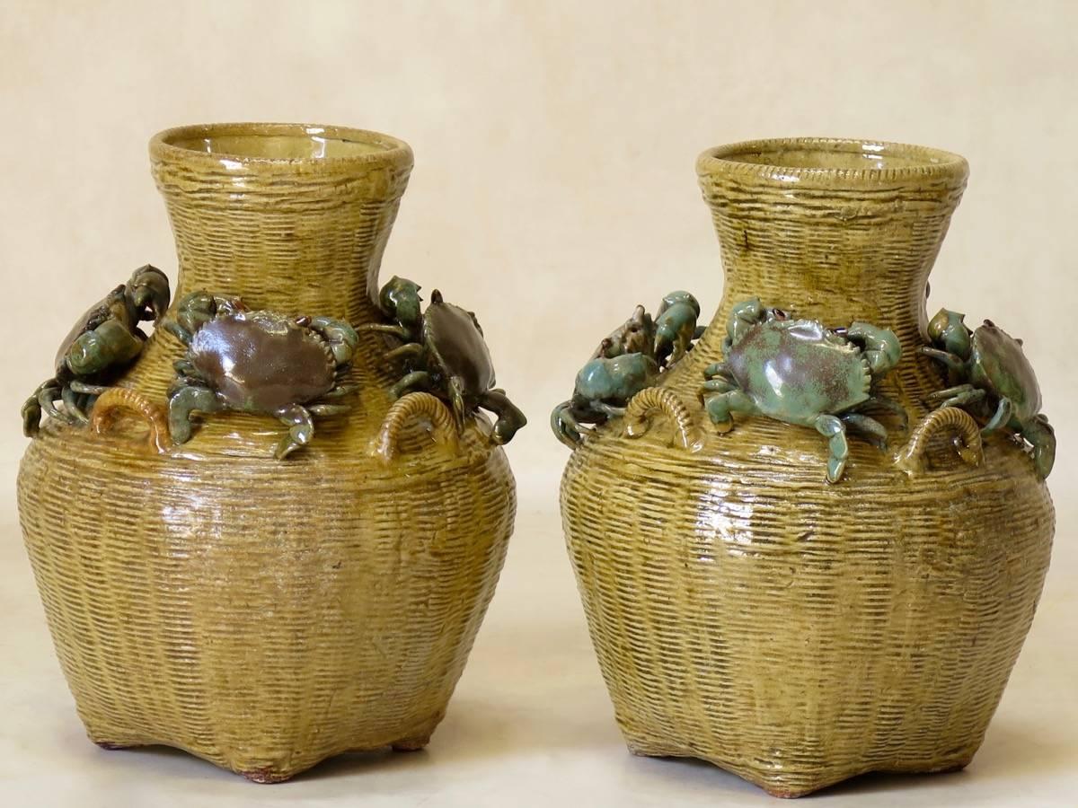 Enchanting and amusing pair of pleasingly rotund Barbotine vases, representing crabs forming a ring around woven baskets. The inspiration is taken from the French expression 