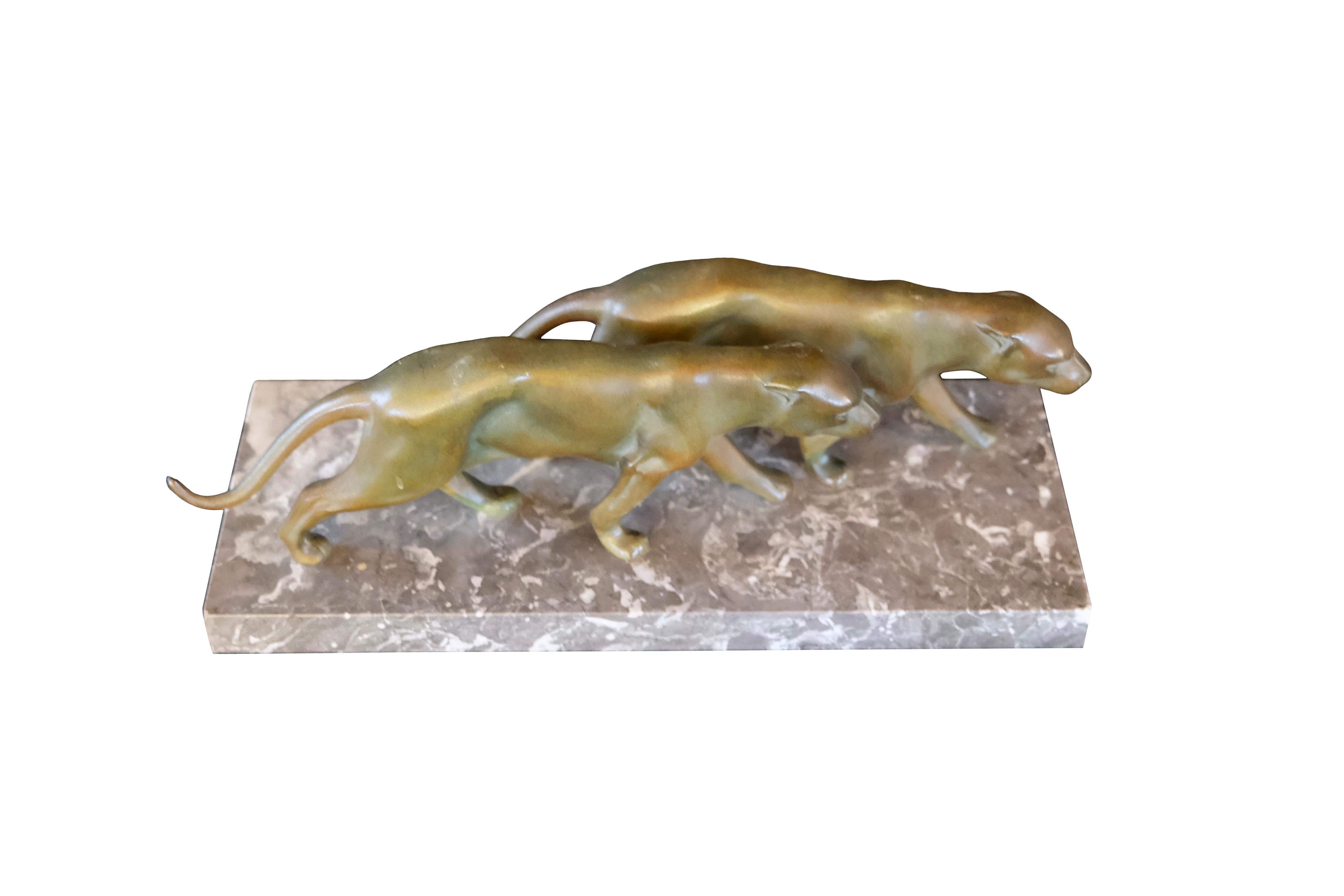 Two walking panthers 
Spelter sculpture on a marble base 

Original Art Deco, France, 1930s 
Original Patina

Dimensions: 
Width 40 cm
Height 15 cm
Depth 16 cm.