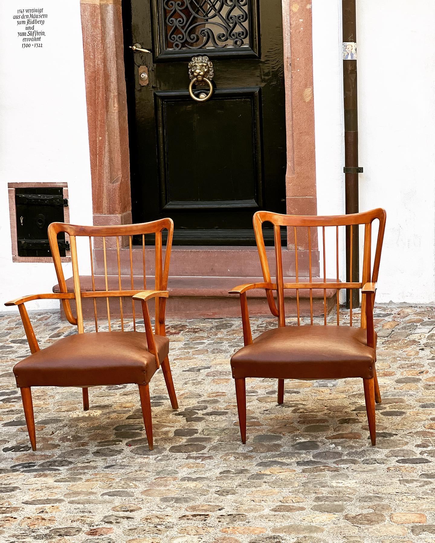 Beautiful pair of chairs made by Paolo Buffa in 1950. Frames made in cherrywood with a beautiful warm patina. The seats are upholstered in its original burgundy leather. 

The curvature of the backrest and the armrests are very typicalk for Buffas