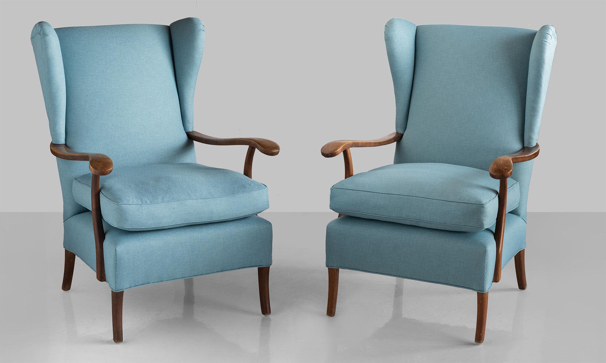 Pair of Paolo Buffa armchairs, Italy, circa 1950.

Modern wingback armchairs with carved wooden arms, newly reupholstered in Maharam Fabric.