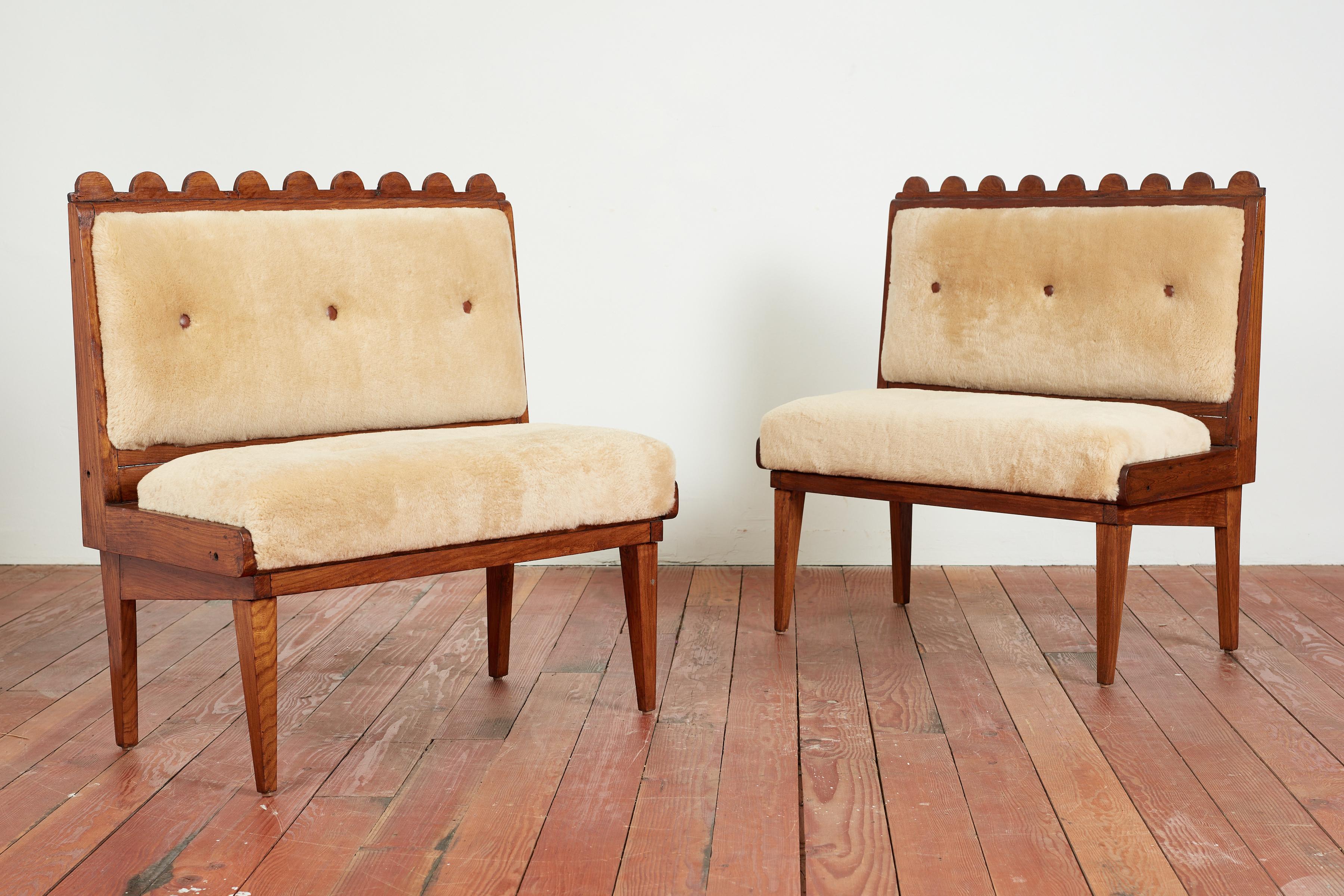 Pair of Paolo Buffa attributed benches in chestnut wood with signature scalloped edge

Reupoholstered in camel shearling and leather button tufting

Seat hinges open to reveal storage. 

Wonderful pair - sold as a pair

France, 1950s.