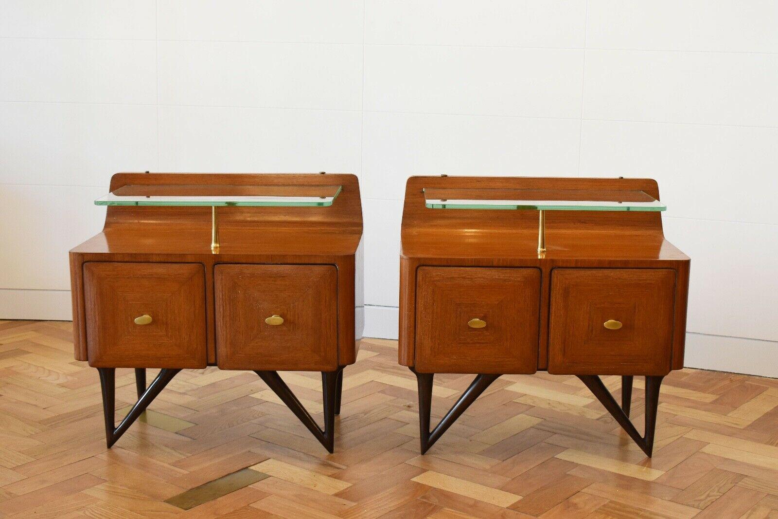 A beautiful pair of Italian 1950's rosewood cupboards in the manner of Paolo Buffa, perfect to be used as bedside tables. 

A very rare and stylish design, this pair comprise of their original glass shelf, with a two door compartment and their