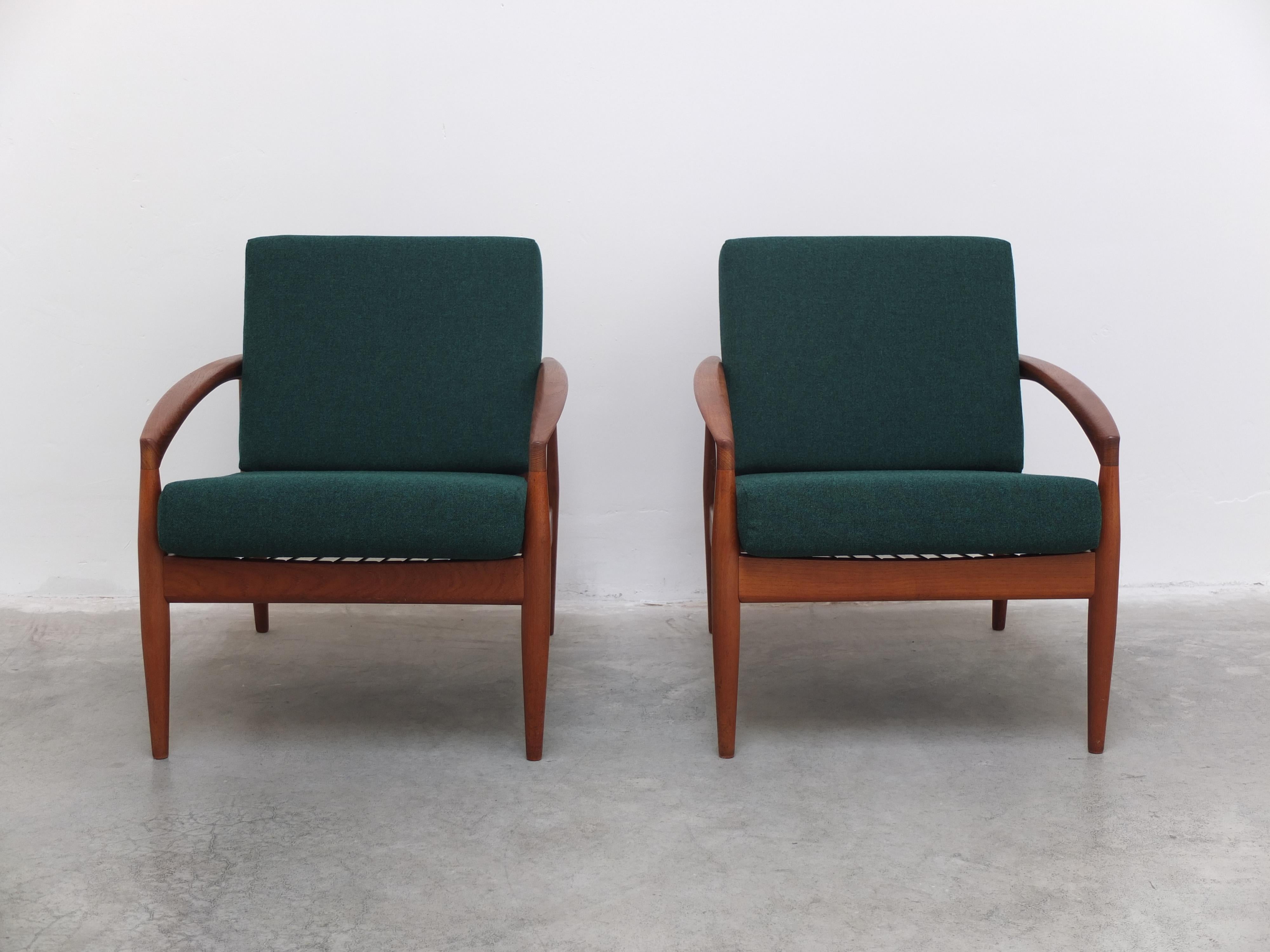 Magnificent pair of ‘Model 121’ easy chairs designed in 1956 by Kai Kristiansen and produced by Magnus Olesen in Denmark. Beautifully crafted solid teak frames with the signature armrests that give these chairs their nickname ‘Paper Knife’. The