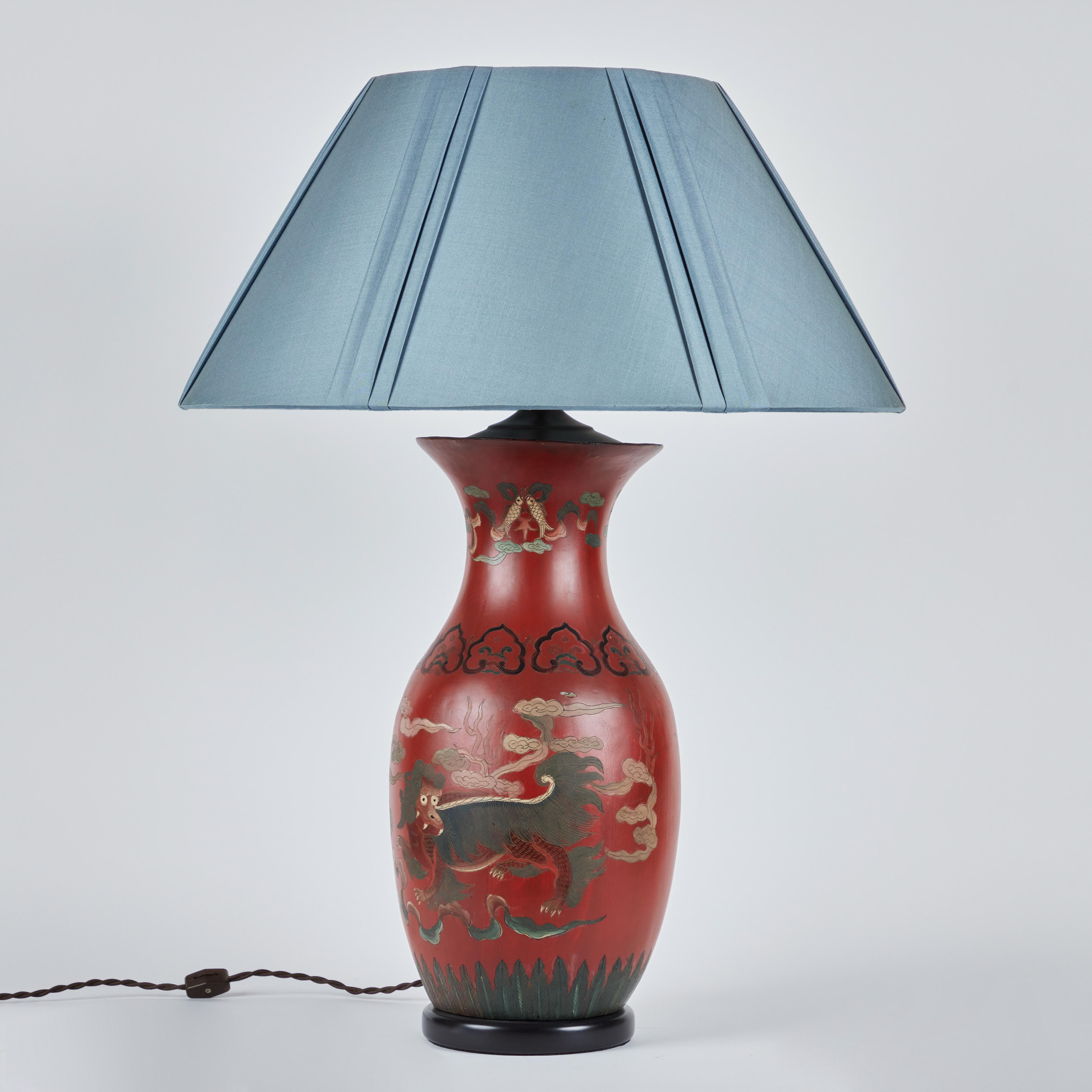 A pair of hand painted Chinese papier-mâché lamps on ebonized wooden bases. Stylized dragons and koi fish are the featured decoration. New custom silk lampshades are 21