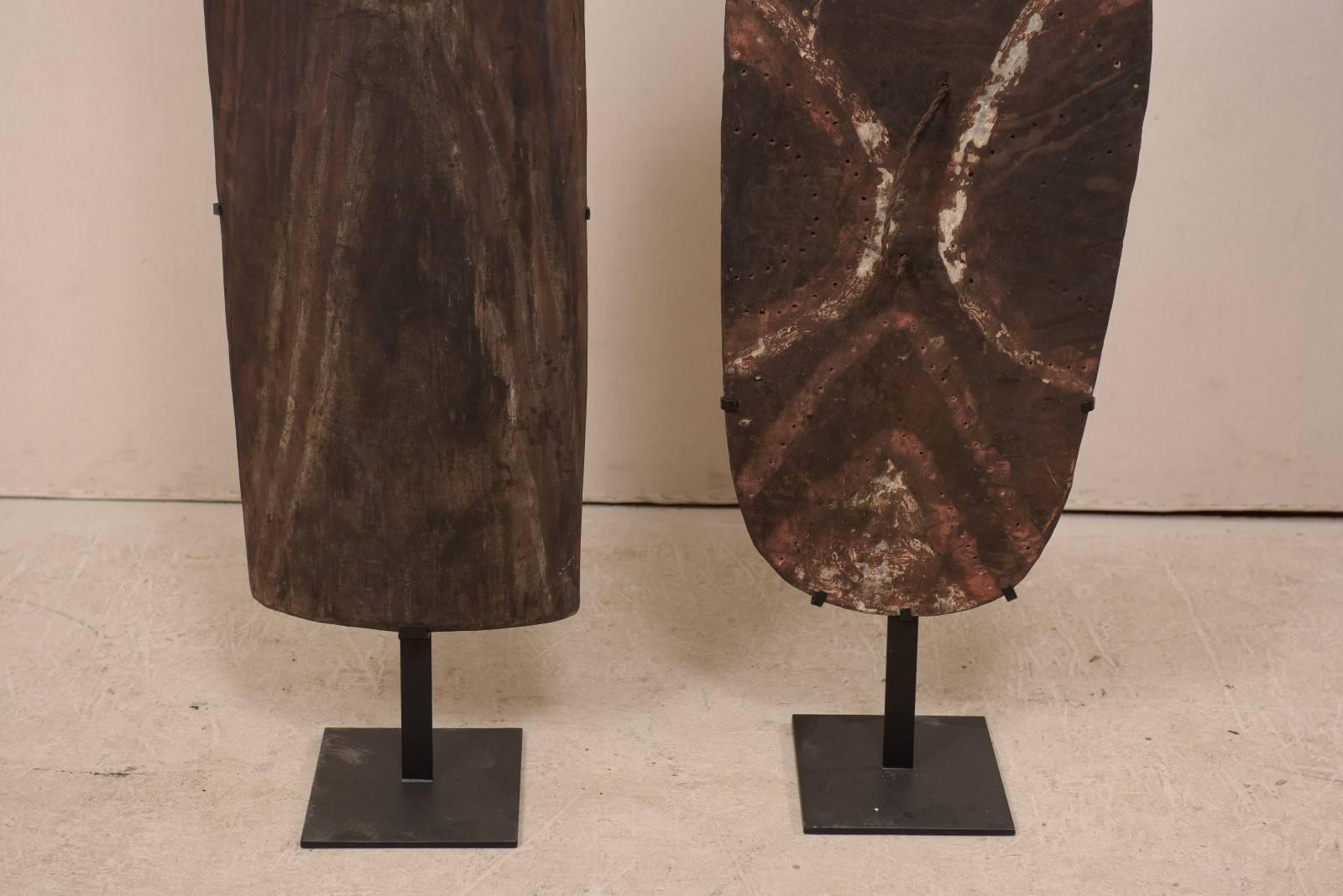 Carved Pair of Papua New Guinea Wooden Oceanic War Shields on Custom Iron Stands For Sale