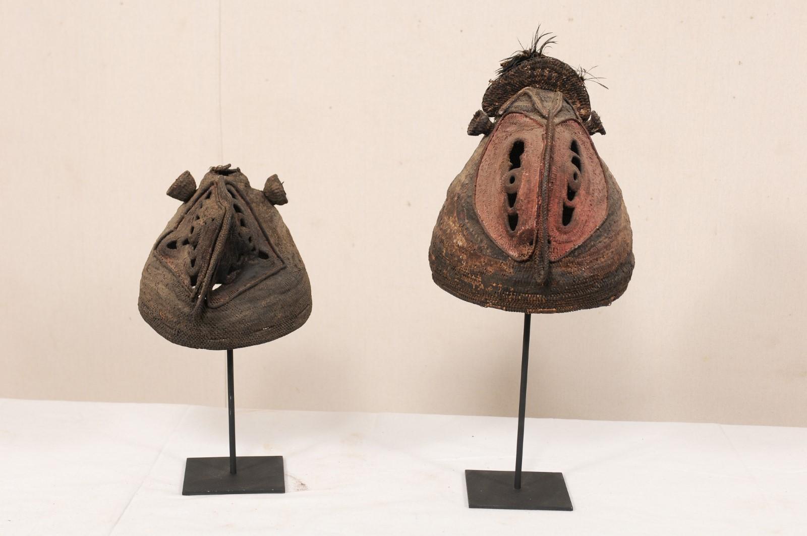 A pair of Papua New Guinea yam festival masks from the mid 20th century. These vintage ceremonial masks, also referred to as a baba mask, originate from the Abelam people, along the East Sepik River Region, of Papua New Guinea. Yam farming was a