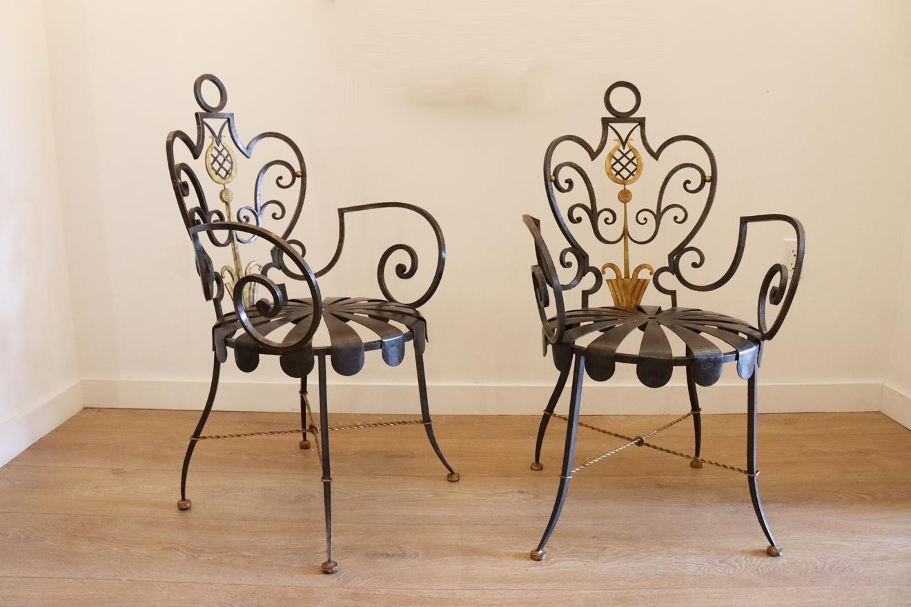 Pair of parcel-gilt wrought-iron armchairs
 by Gilbert Poillerat for compagnie des arts Francais
 France circa 1946
Twisted X-form stretchers, dark and parcel-gilt metal patina 
Available to view in-situ in our Miami gallery
Bibliography:
François