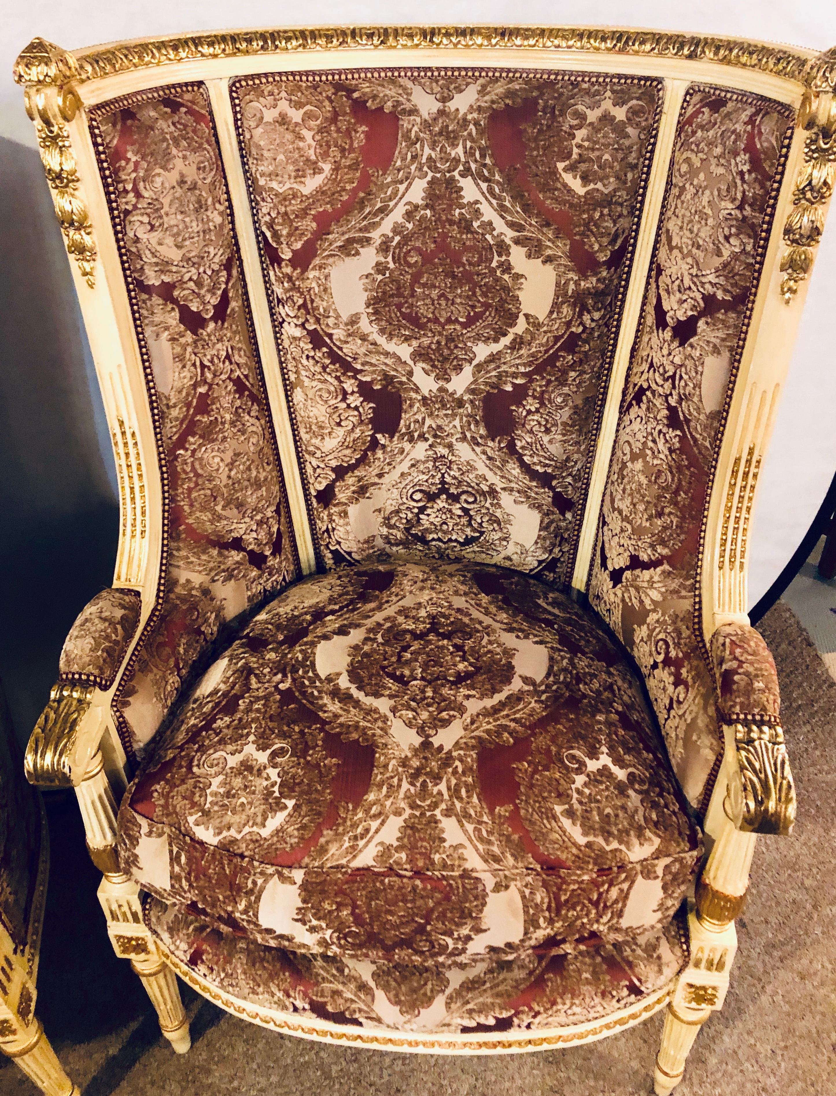 Pair of parcel paint and gilt decorated Louis XVI style wingback armchairs. The fabric in very good new condition.
