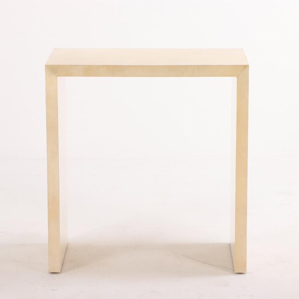 A pair of parchment covered console tables in the manner of Jean-Michel Frank(1895-1941). Contemporary.  Note: the underside is not fully covered in parchment. 