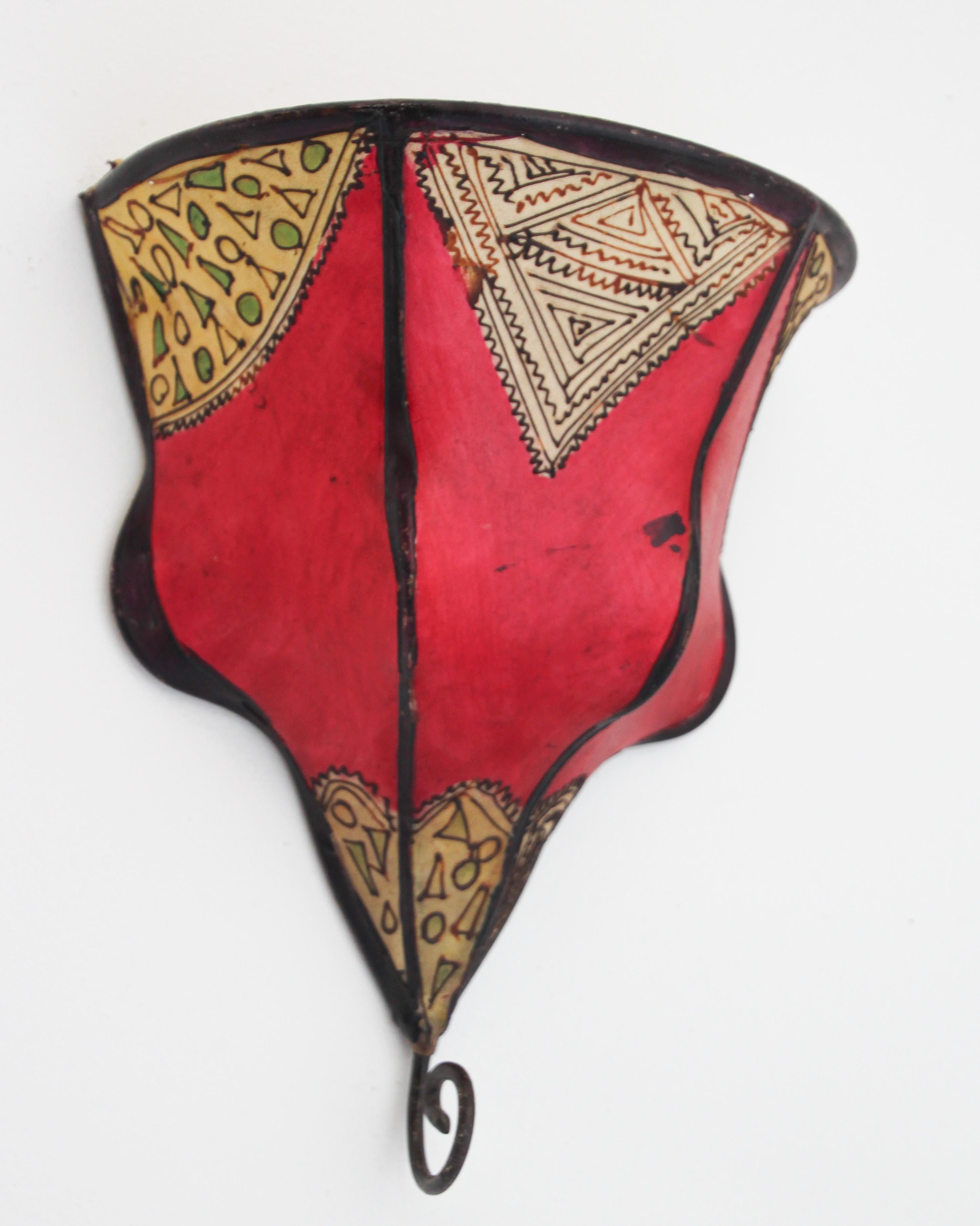 African Tribal Art parchment wall shade sconce featuring a large curved hide form stitched on iron and hand painted surface.
These Moroccan Art pieces could be used as wall lamp shade.
Iron frame covered with hide parchment which has been hand
