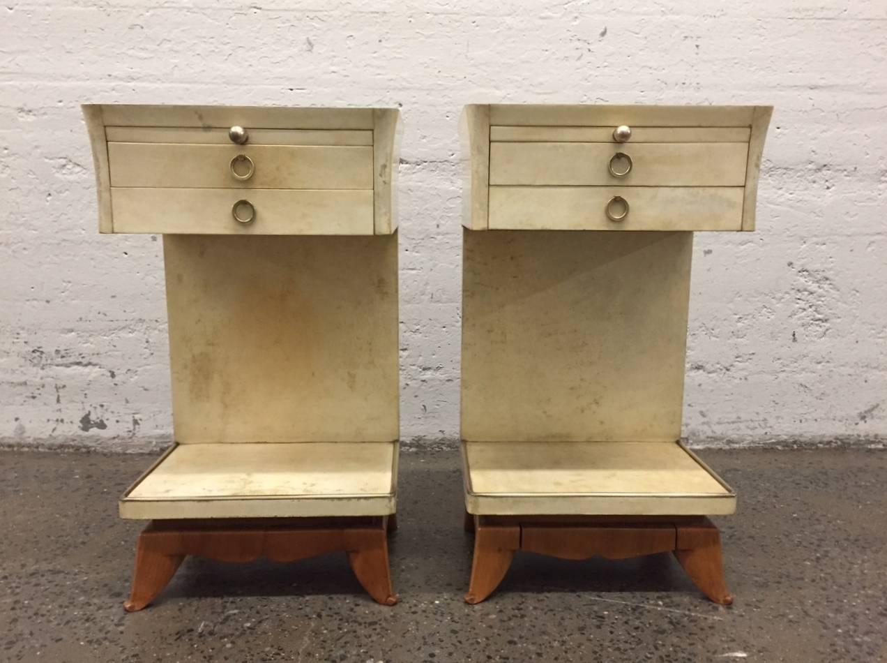 Nightstands have two pull-out drawers, a pull-out tray and bronze hardware. Nice sculpted wood legs. Has bronze trim to the bottom of the shelf.