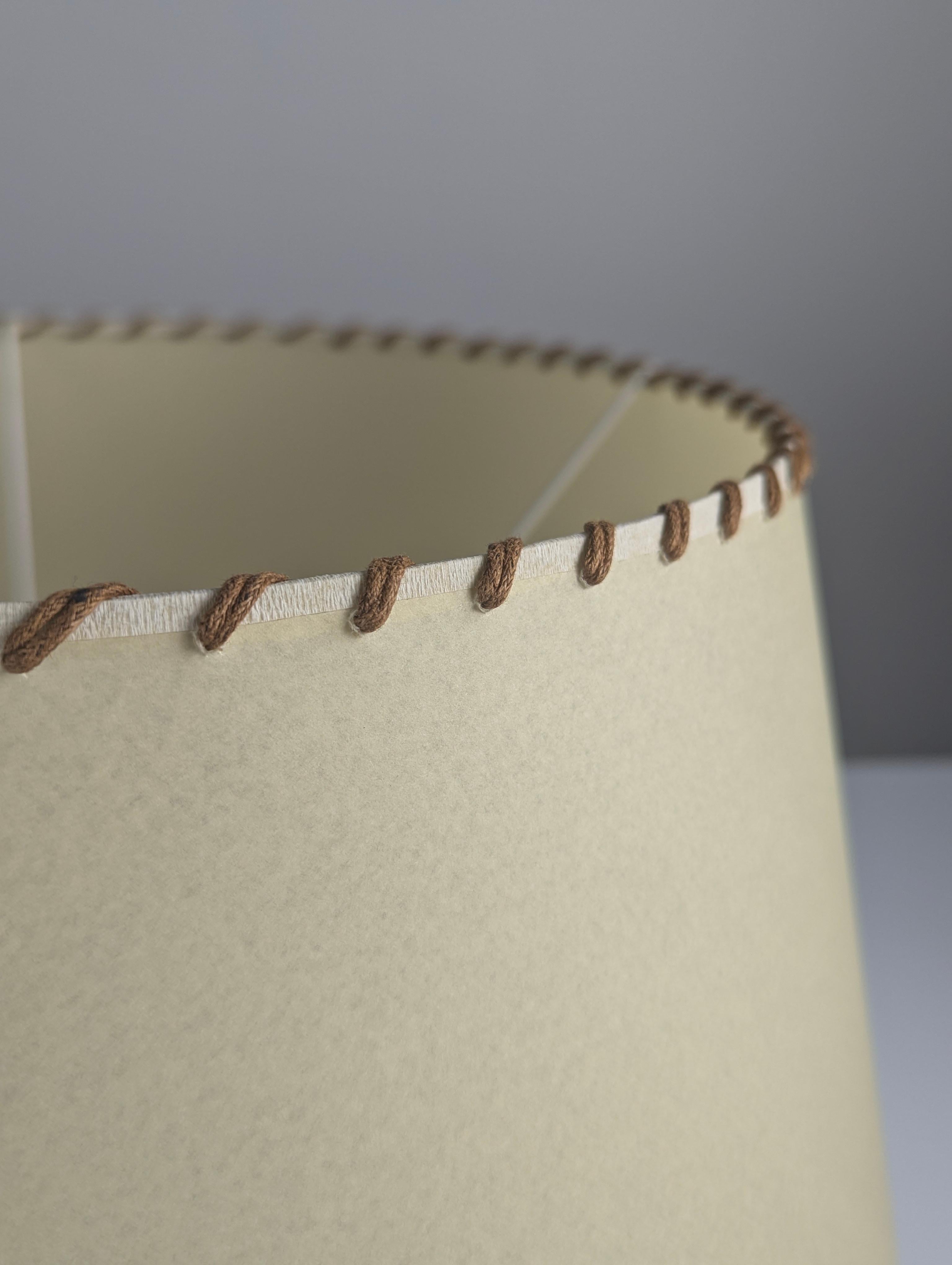Beautiful pair of lampshades made from parchment with hand-sewn rope edges.