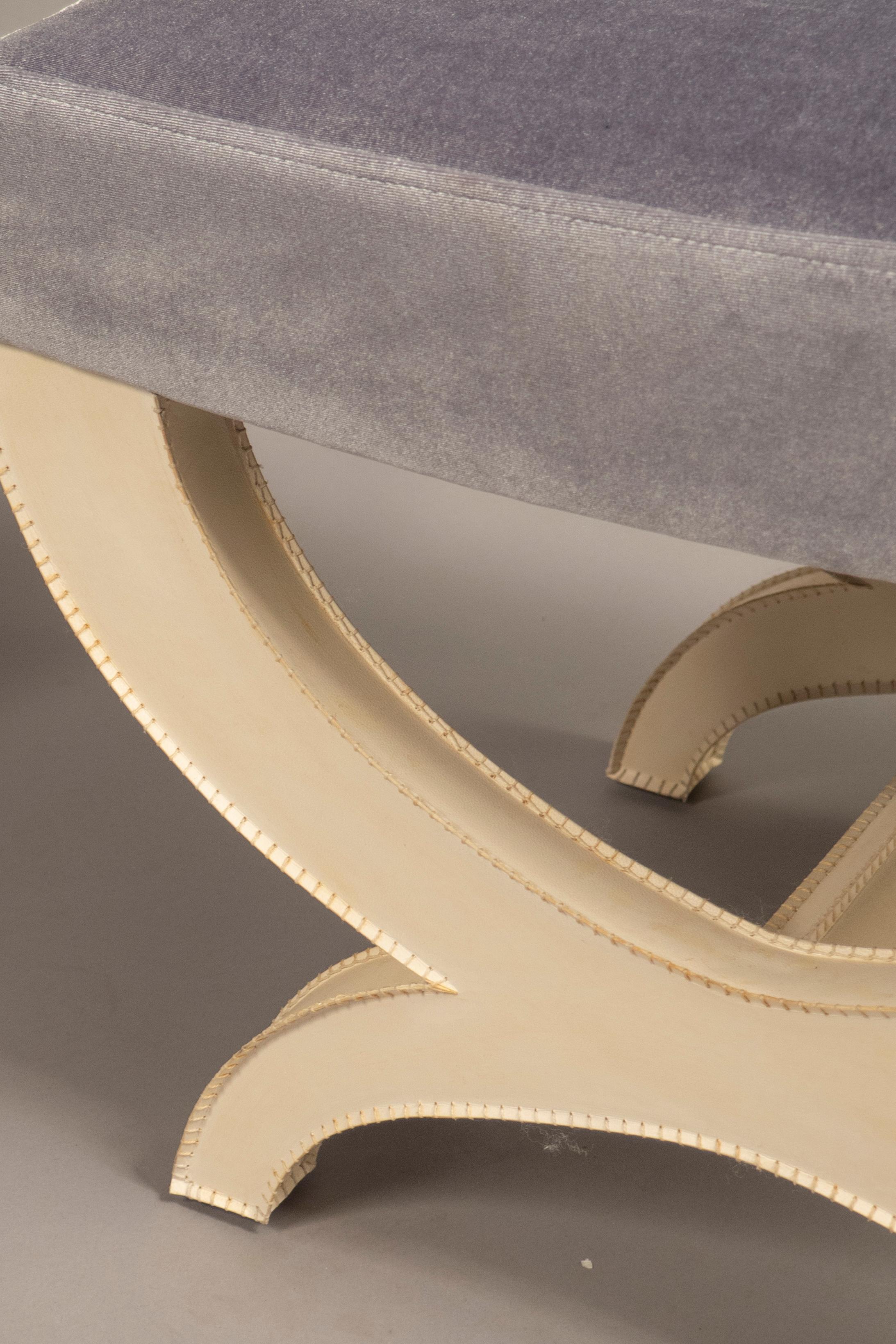 Parchment covered x-stools, the edges of the parchment featuring overstitch technique. Two pairs available.
 