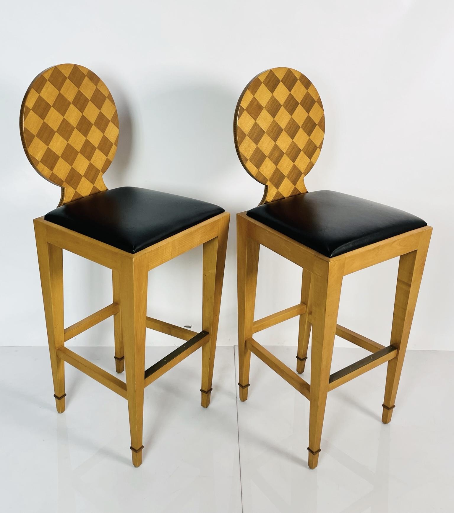 Beautiful pair of barstools designed and manfactured in the USA by John Hutton and manufactured by Donghia.
The barstools are part of the Paris Hall collection.

The stools are made in solid wood with checkered round backs and upholstered in
