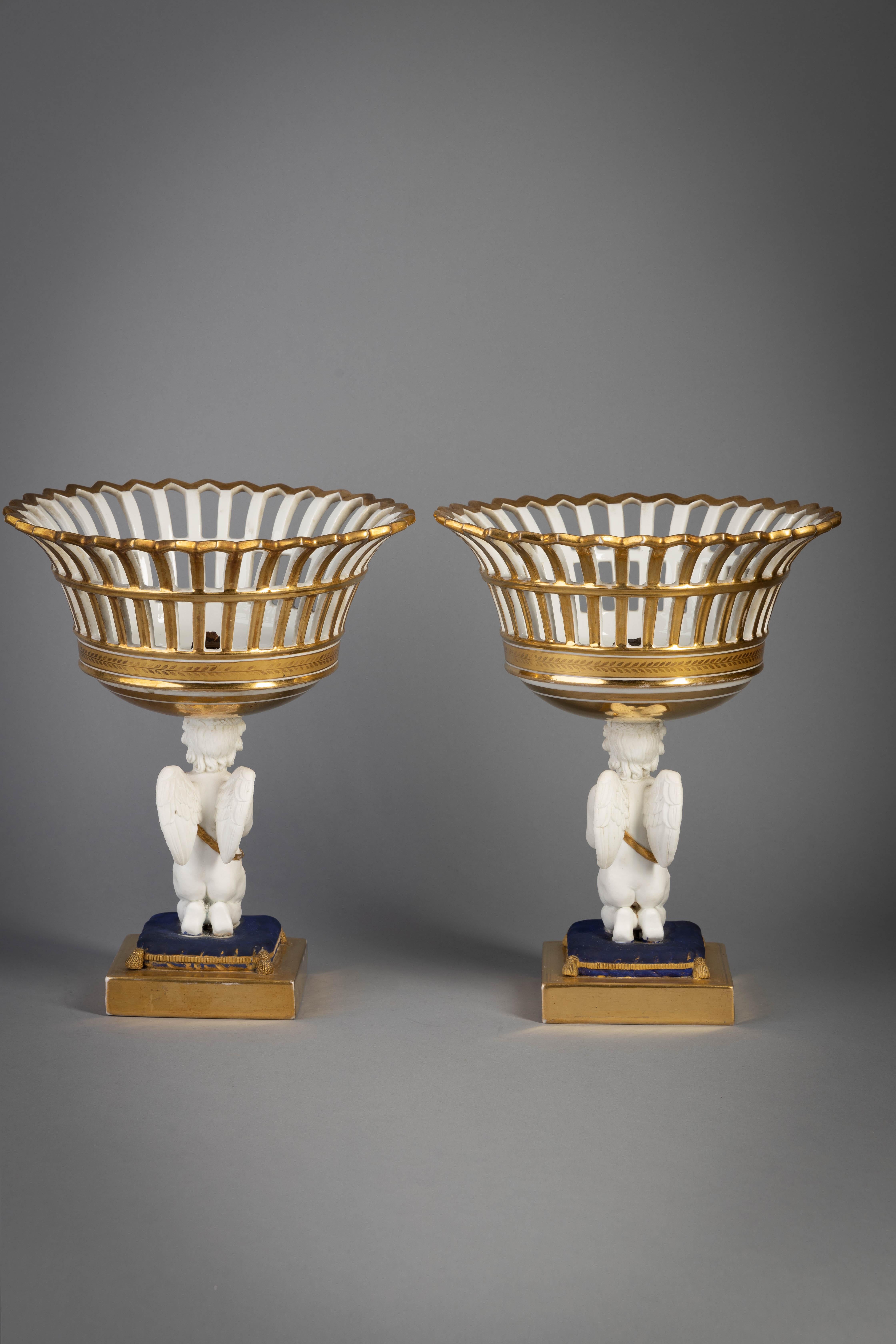 Pair of Paris porcelain figural baskets, circa 1840.