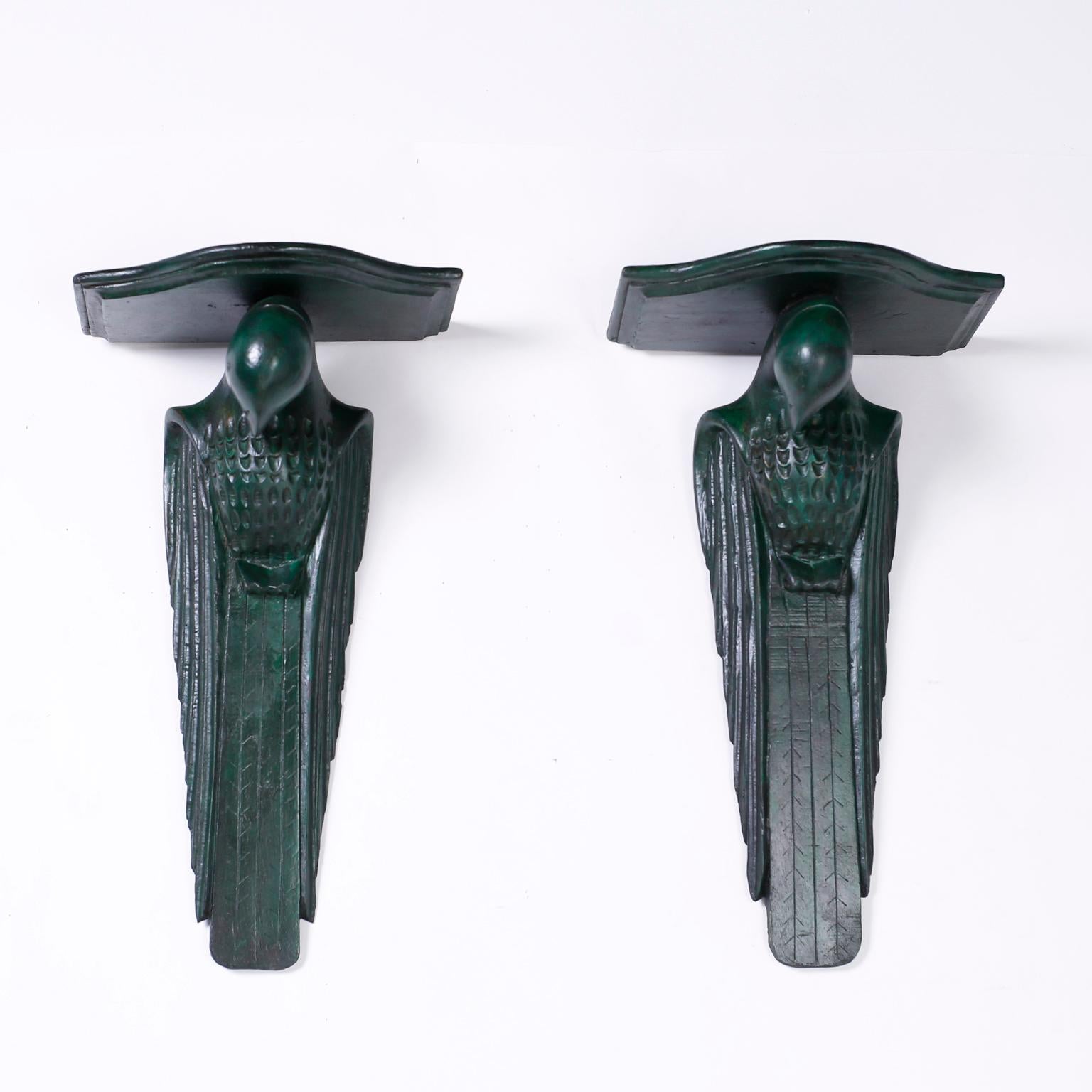 Pair of Anglo-Indian carved wood parrot or bird wall brackets in the Art Deco style with a unique faux verdigris bronze finish.