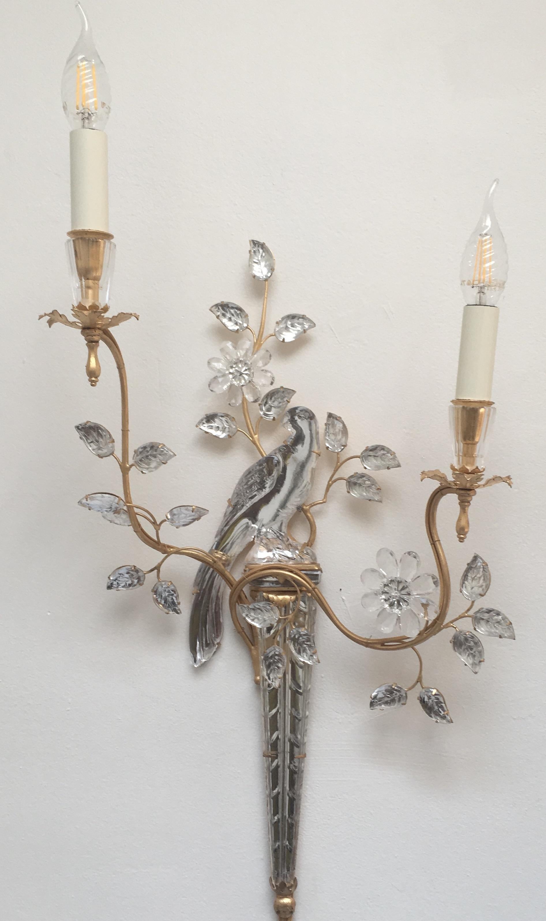 An elegant pair of iconic parrot sconces by Maison Baguès. A Classic design, beautifully executed in gilt and glass with two lights.