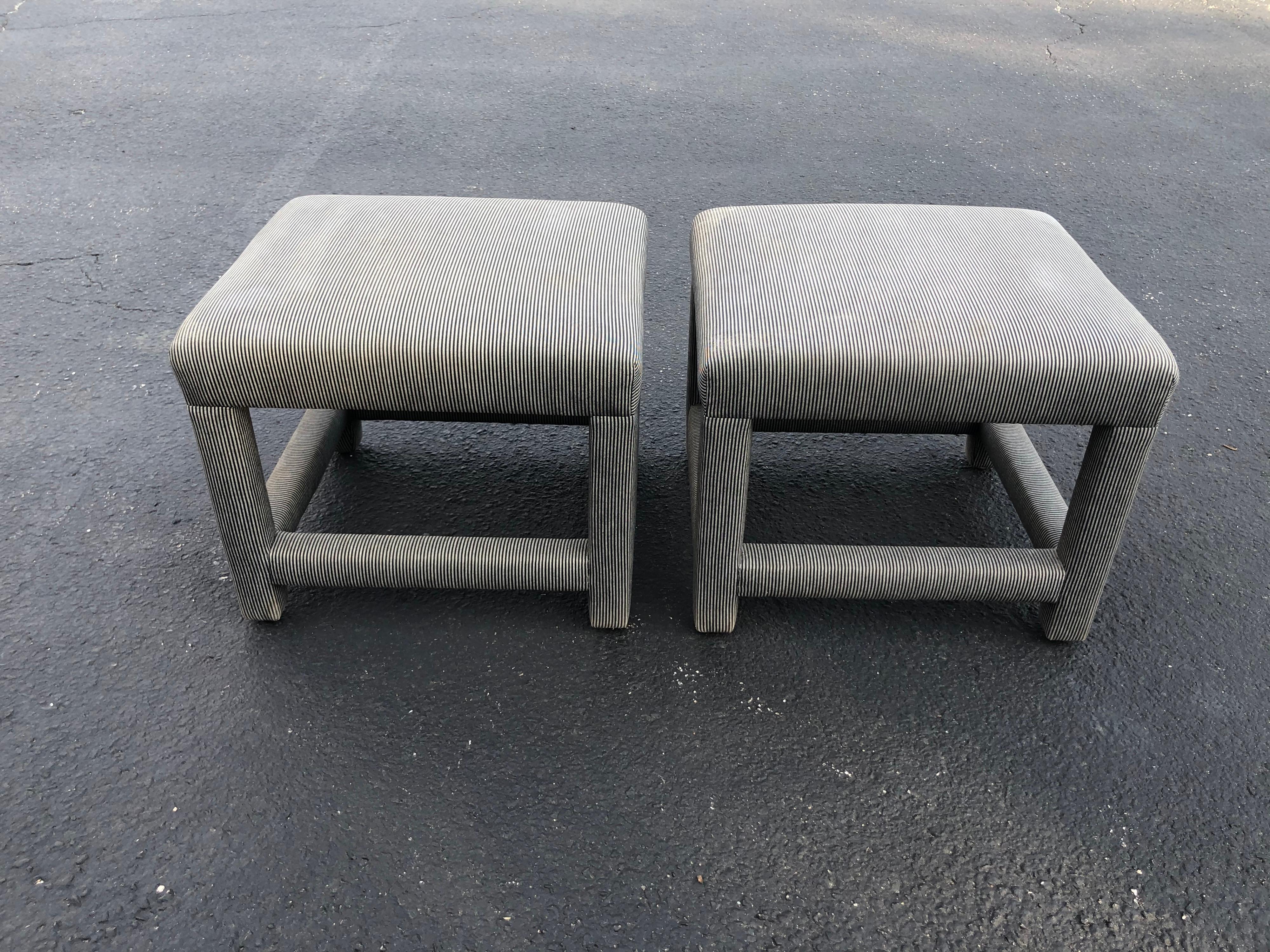 Pair of Parson style foot stools or ottomans. Square in shape and great as end tables or pull up stools. Keep underneath a console. Thin gray black and white pinstripe. Some slight water marks, could use a recover.
  