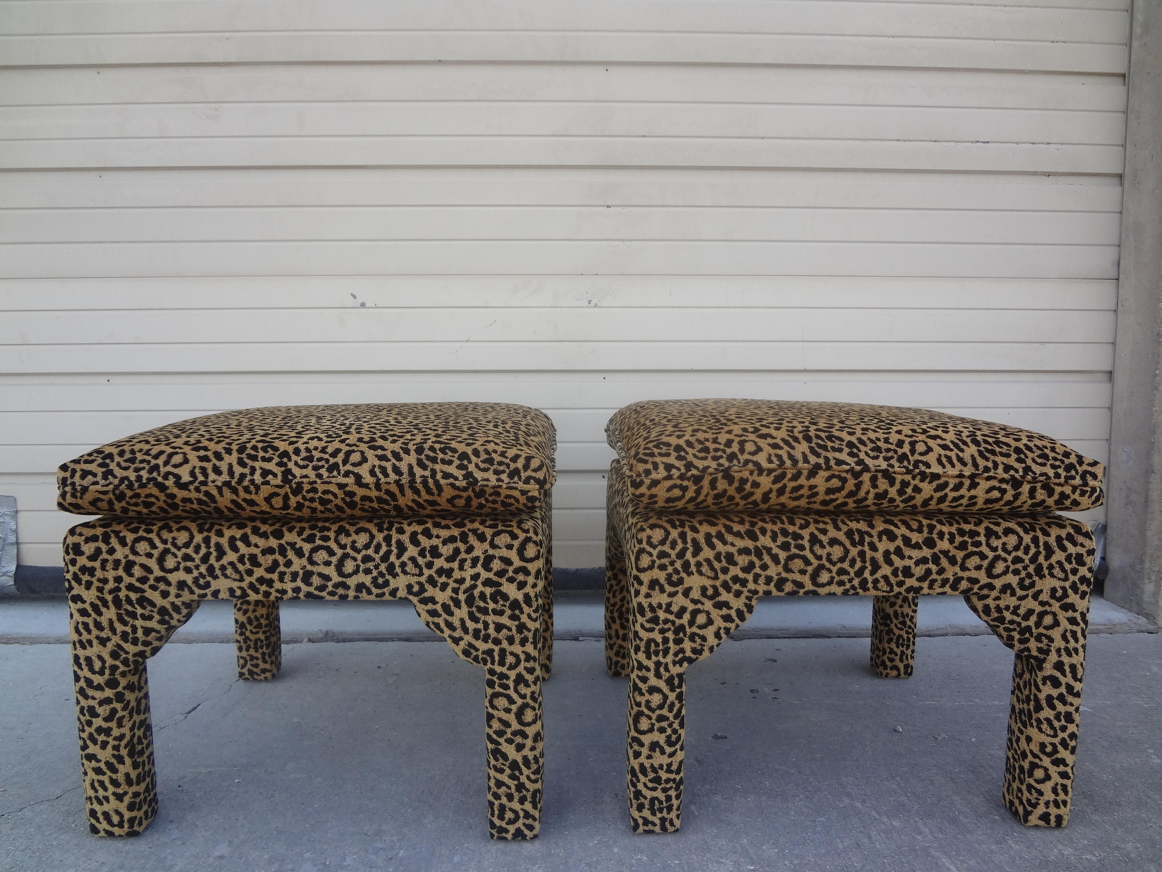 Pair of Billy Baldwin Style Parsons Leopard print ottomans. This stunning pair of Hollywood regency Billy Baldwin style square ottomans, benches, poufs or stools have been professionally upholstered in leopard print chenille. This glamourous pair of