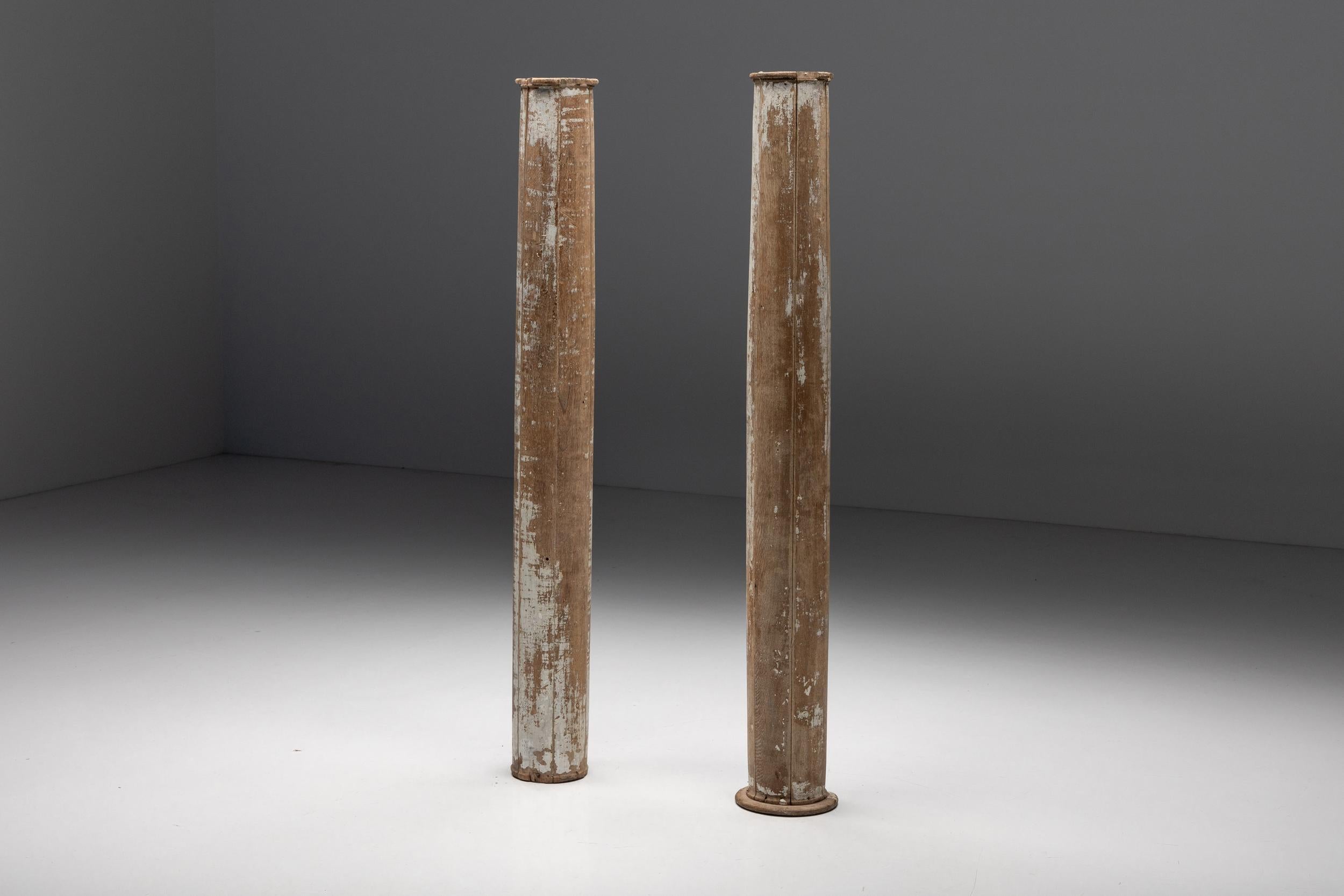 Patinated; Wood; Columns; Pedestal; 19th Century; Rustic; Hallway; Foyer; Entry; 

These partly patinated wooden columns date from the 19th century. They have a rustic feel and would fit well in a monumental hallway, foyer or entry. This set of