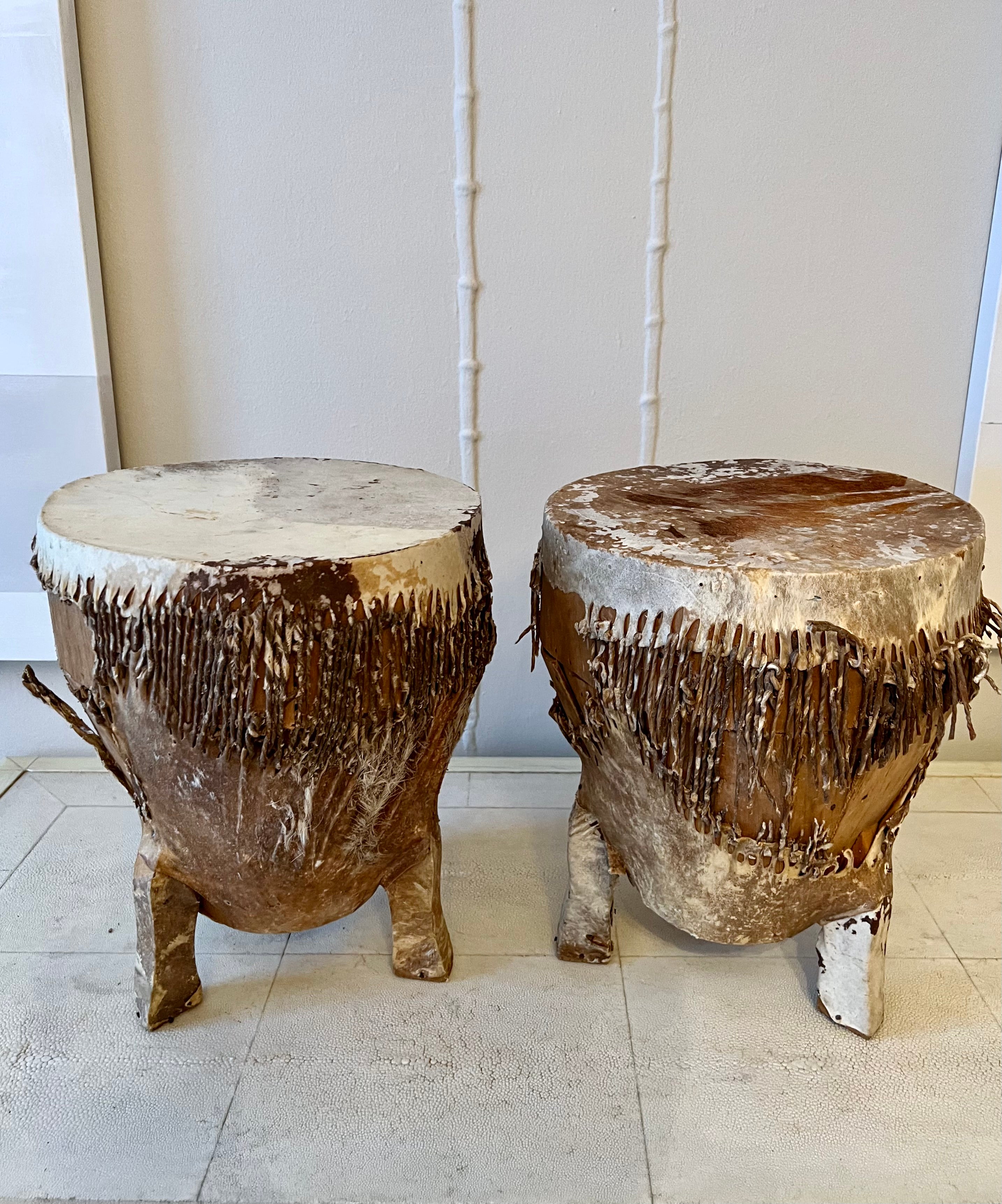 Beautiful pair of African zebra drums. Great side table or beat it! Heavily patinated, gives these a more whitewashed look - a wonderful textural addition to any room. A compliment to ethnic or tribal interiors. We love the very worn look of the