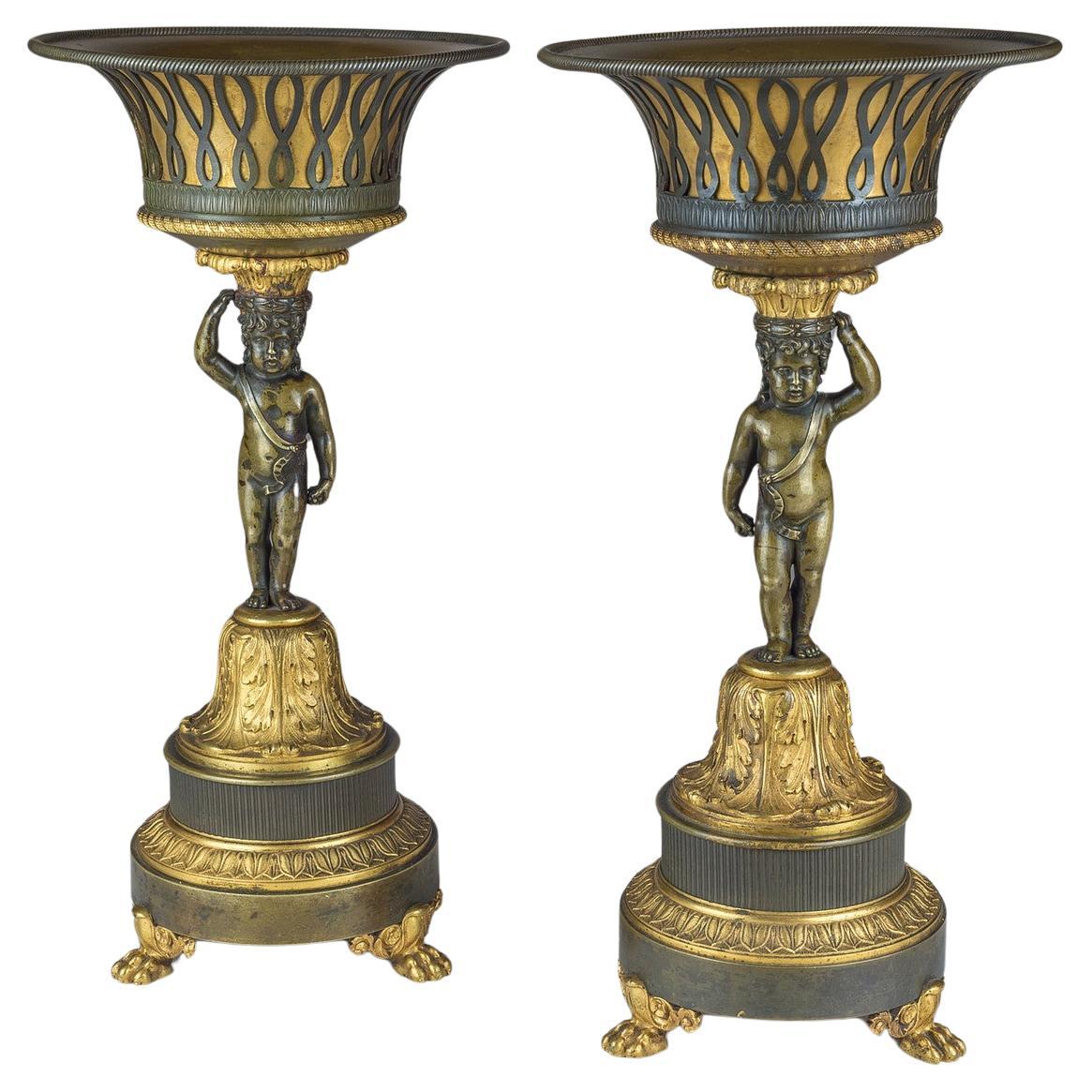 Paar figurale Empire-Tazzas/Tasse aus patinierter und vergoldeter Bronze mit Figuren 