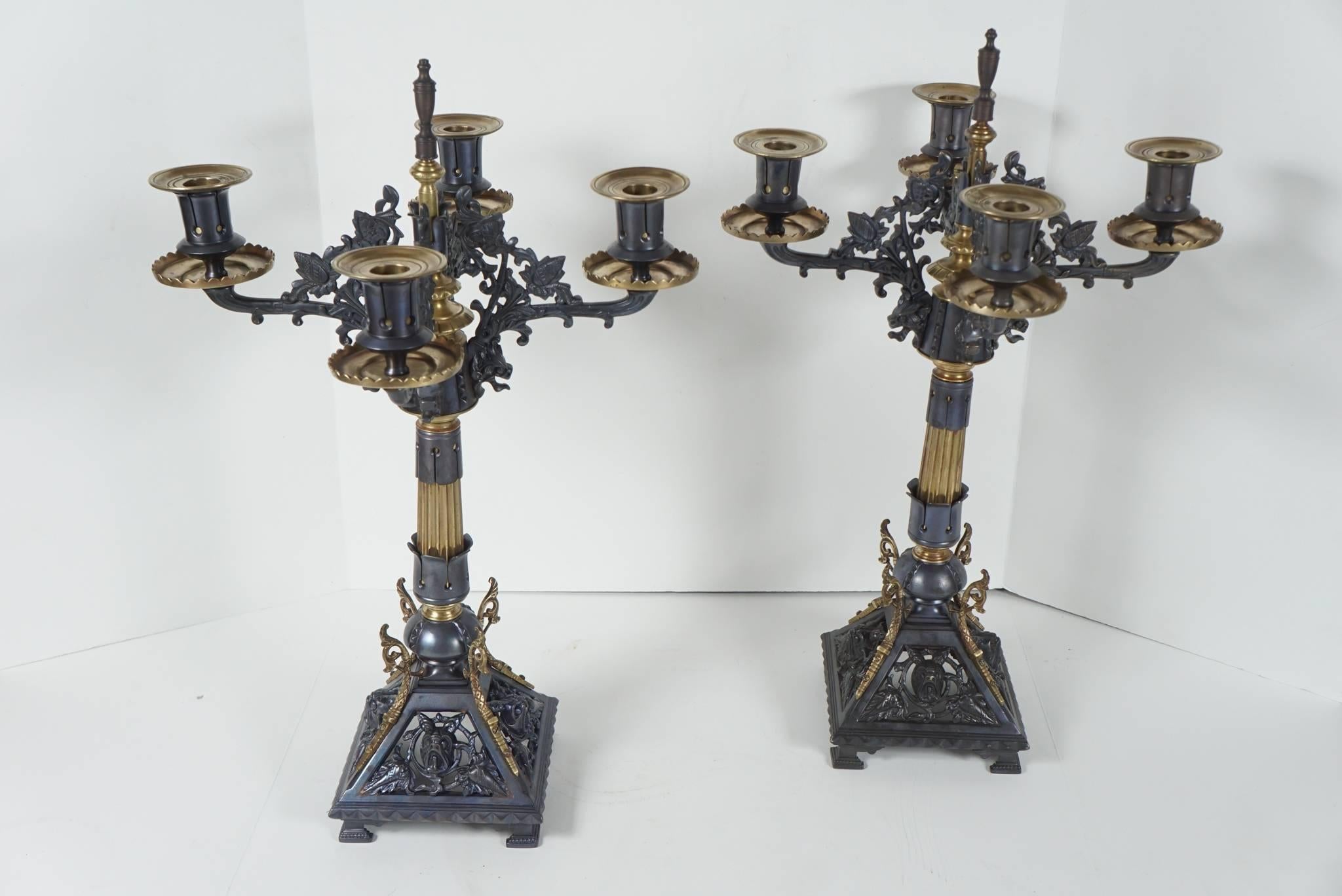 This pair of candelabra made in France, circa 1880 are designed in the Renaissance Revival style. Well cast in a large number of separate parts and patinated and polished to create drama and decorative detail the pair is of a nice scale without