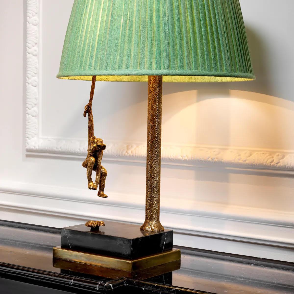 Pair of patinated brass and black marble table lamps

Add a fun, tropical touch to your interior with this pair of table lamps, featuring a swinging monkey.
Comprising a patinated brass base resting on a black marble pedestal, it is topped with a