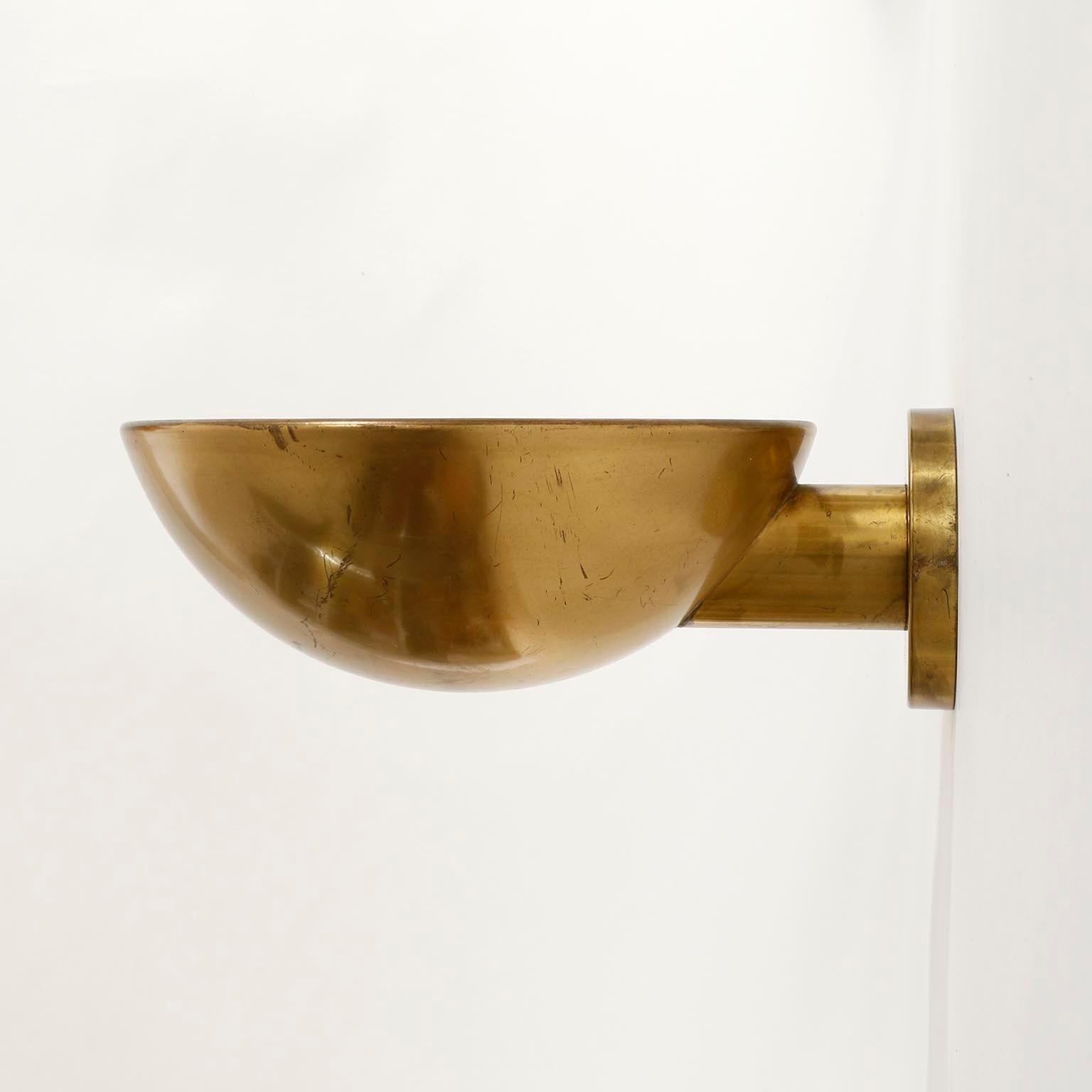 A pair of half moon up light wall lights by J.T. Kalmar, Vienna, Austria, manufactured in midcentury, circa 1960 (late 1950s to early 1960s).
The fixtures are made of solid polished brass which have an aged surface in a rich and warm tone with great