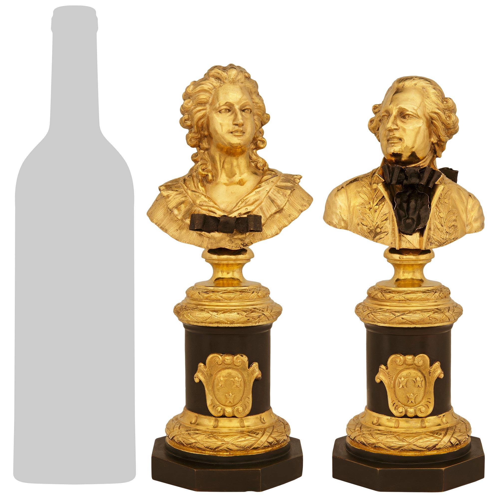 An elegant and most charming pair of French 19th century Louis XVI st. patinated Bronze and Ormolu busts of Louis XVI and Marie Antoinette. This stunning pair are raised on hexagon shaped patinated Bronze bases below circular laurel bands with