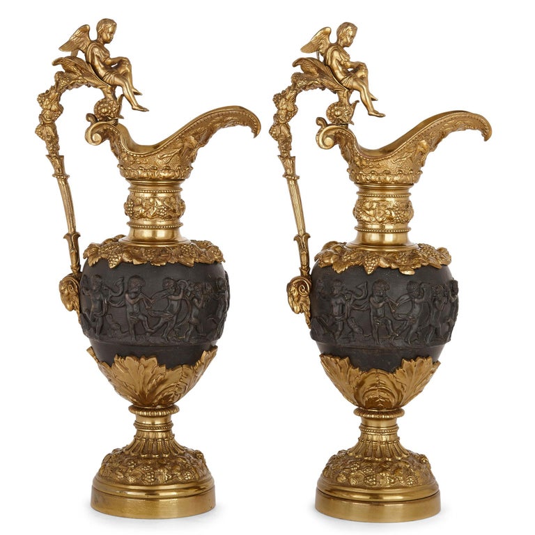Pair of patinated bronze and ormolu ewer vases
French, late 19th century
Measures: Height 54cm, width 23cm, depth 18cm

Each vase in this pair, wrought in the Louis XV style, is formed from a combination of gilt and patinated bronze. The