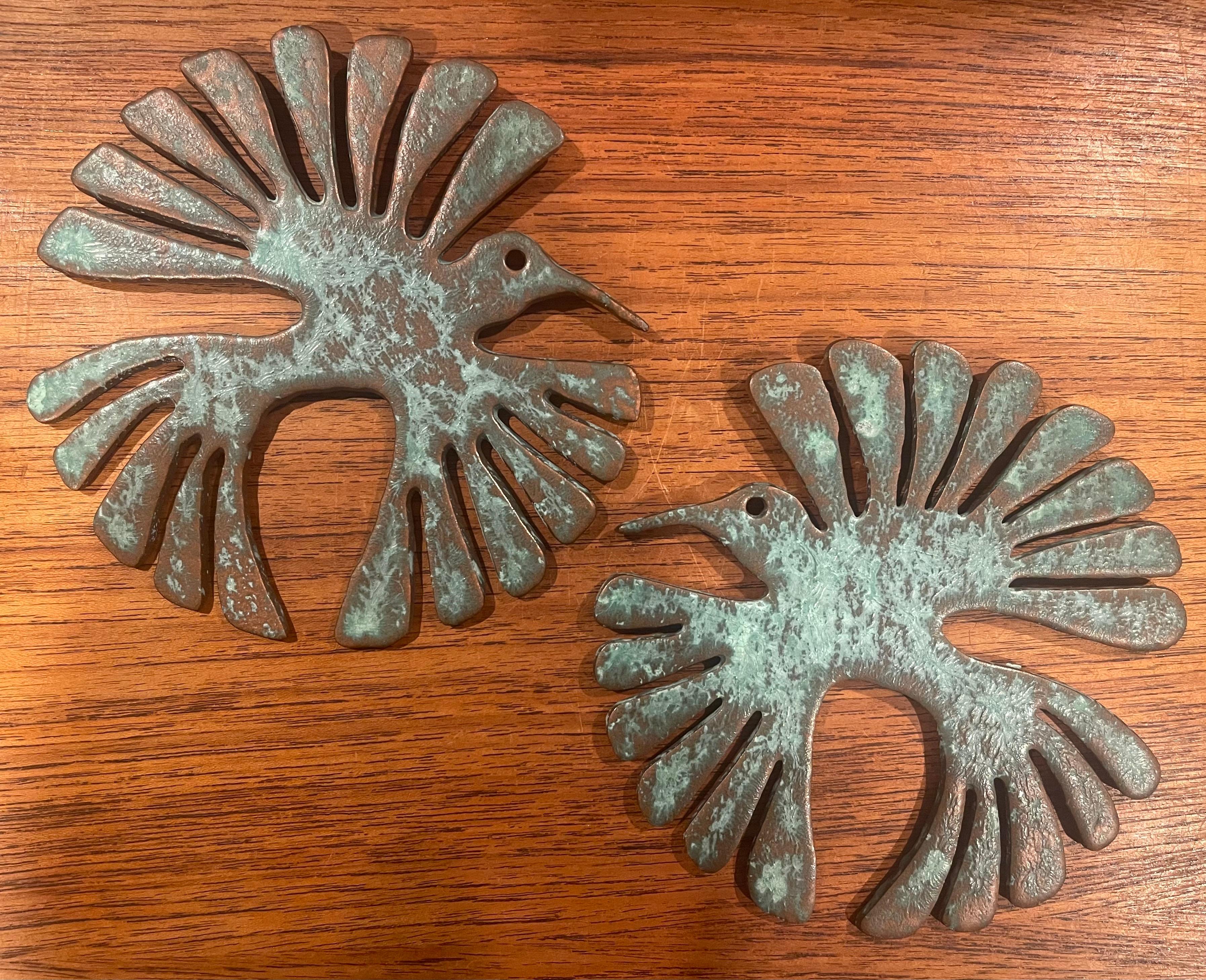 Pair of patinated bronze bird wall hangings with a verdigris finish, circa 1980s. The pair are in very good condition with nice detail and a gorgeous patina. Each bird measures 6