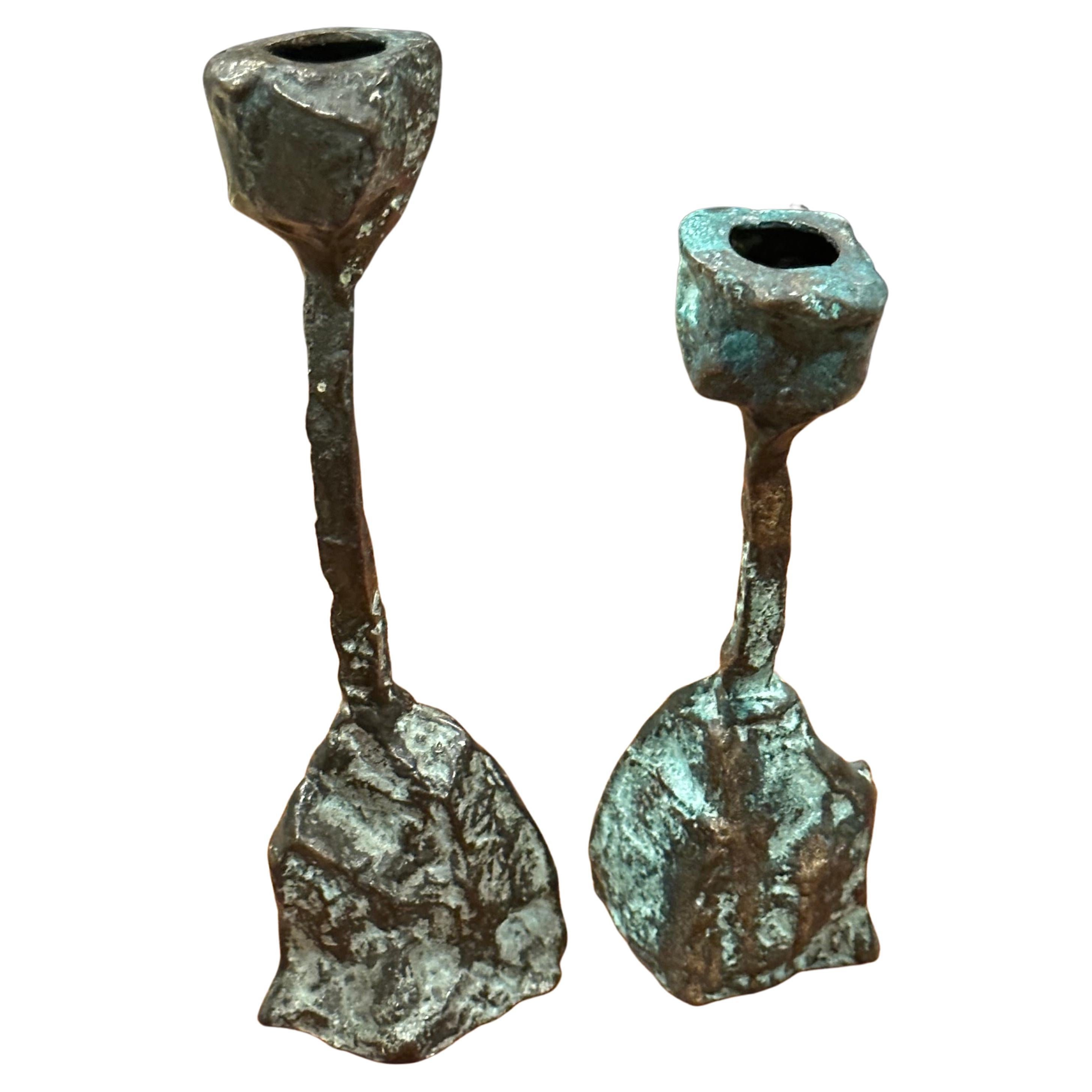 Pair of patinated bronze brutalist candlesticks in the style of Paul Evans, circa 1970s.  The unique looking pair are in good vintage condition with a wonderful patina and measure 2.5