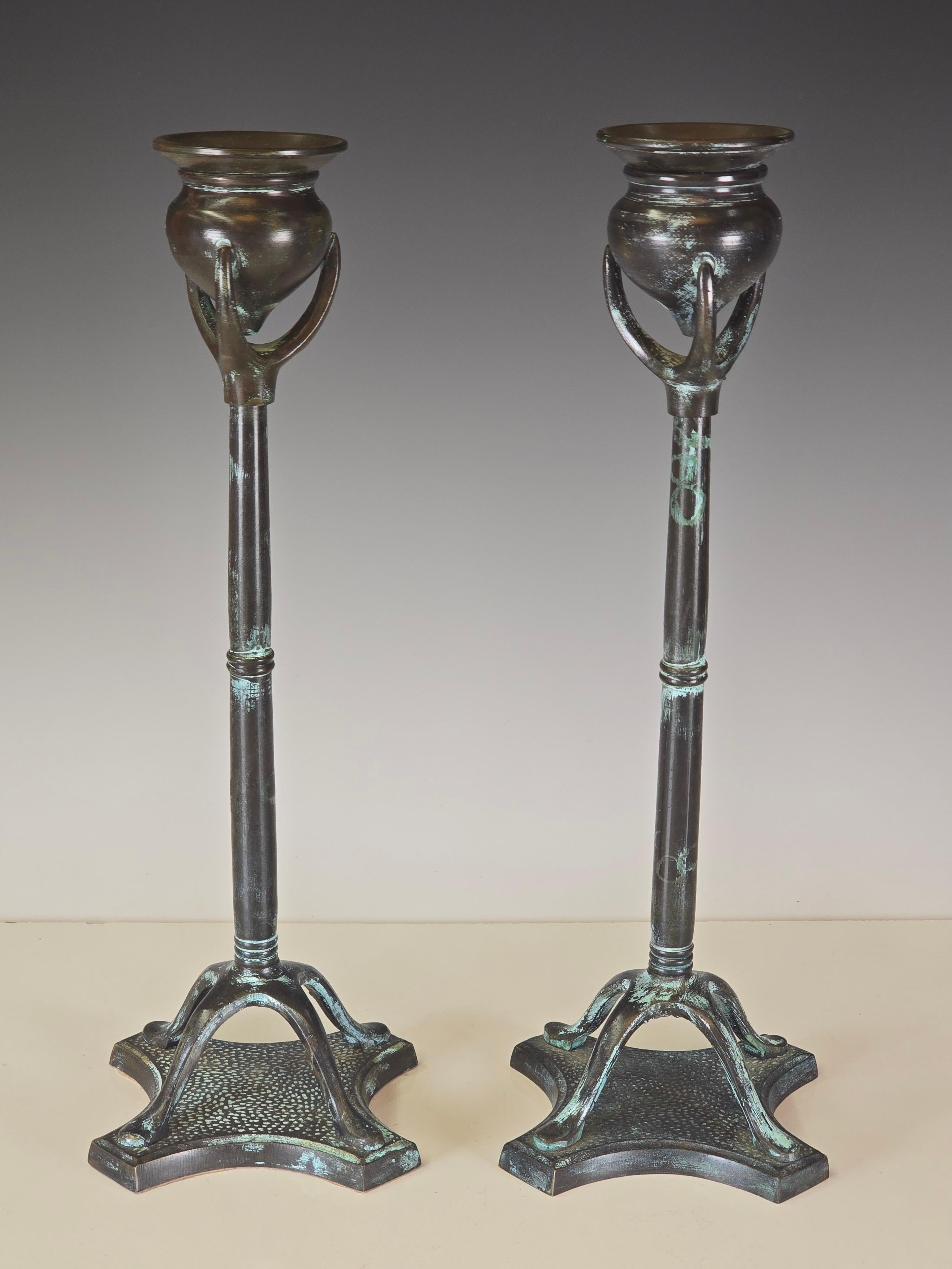 Pair of patinated bronze candlesticks which were influenced by Louis Comfort Tiffany in its design.     