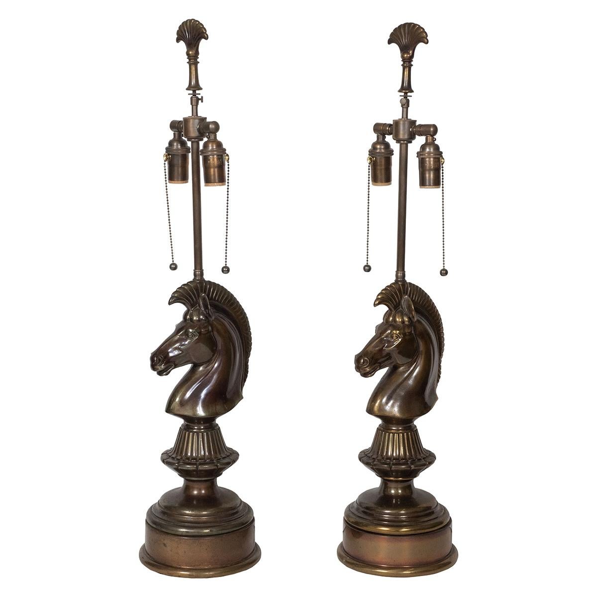 Pair of patinated bronze lamps with chess piece knight (horse) design.