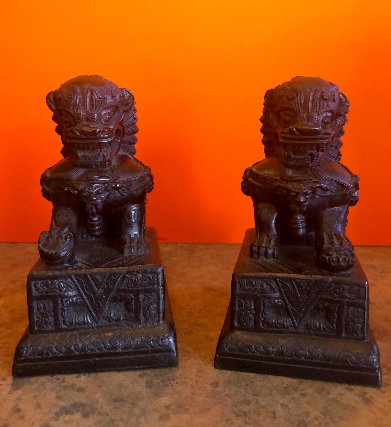 Impressive pair of patinated bronze Chinese foo dogs / book ends, circa 1930s. Excellent vintage condition with amazing detail and a gorgeous patina. Each dog measures 6.5