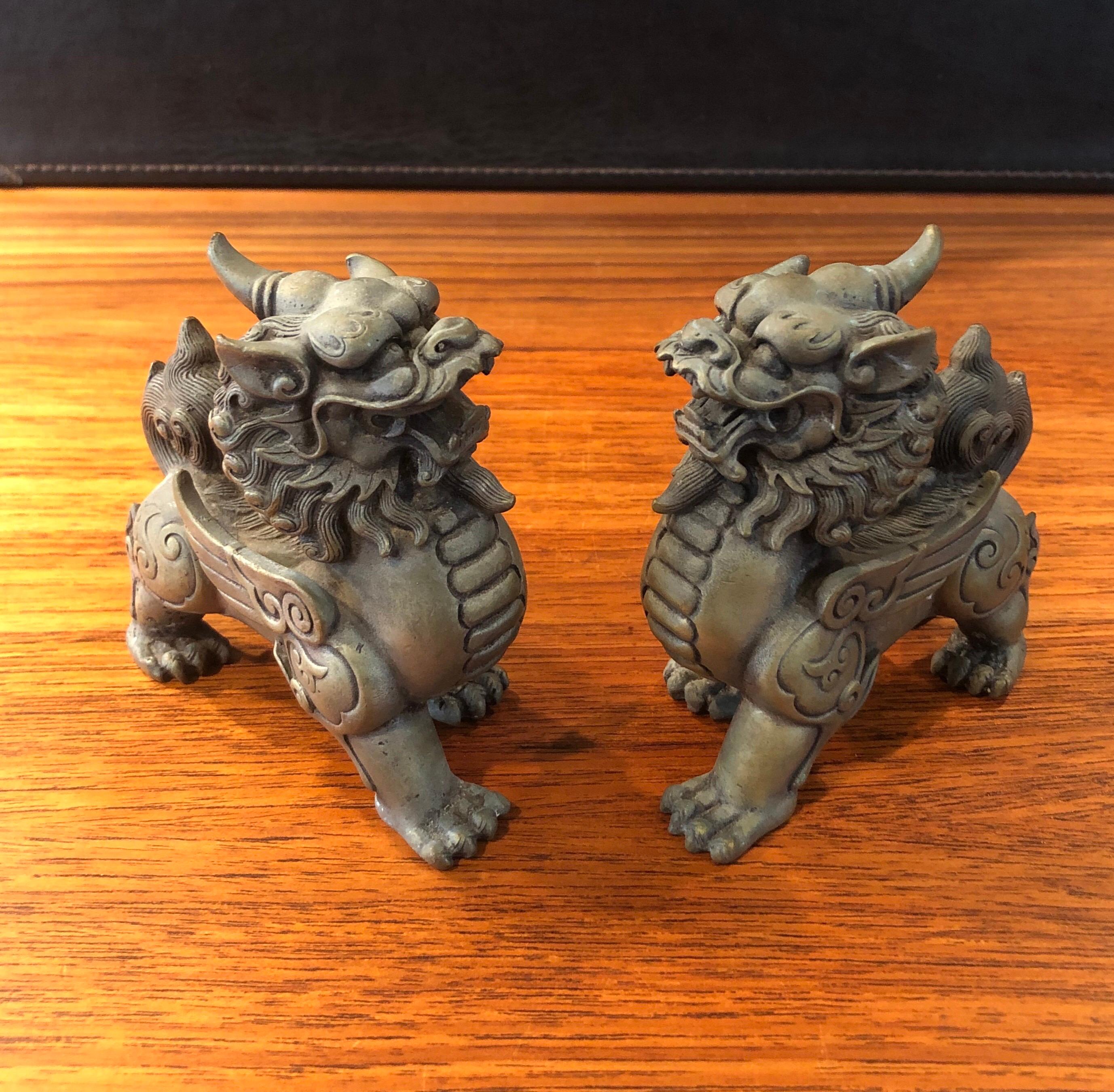 Pair of patinated bronze Chinese foo dogs, circa 1930s. Excellent vintage condition with amazing detail and a gorgeous patina. Each dog measures 6.5