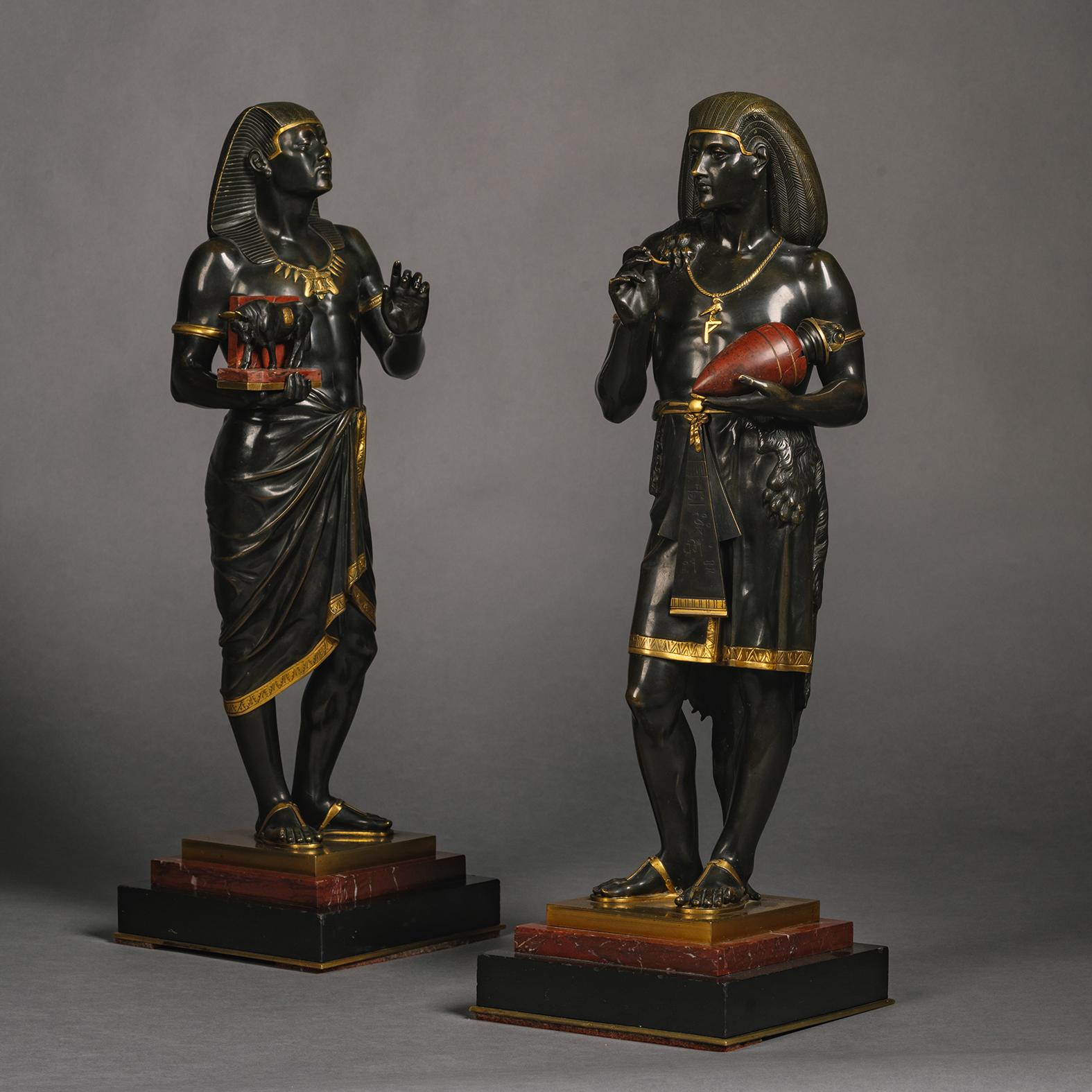 Paire de figurines en bronze patiné représentant le grand prêtre égyptien Pastophore et le scribe égyptien Hierogrammate, par Emile Louis Picault (français, 1833-1915).
   
Chaque exemplaire est signé 