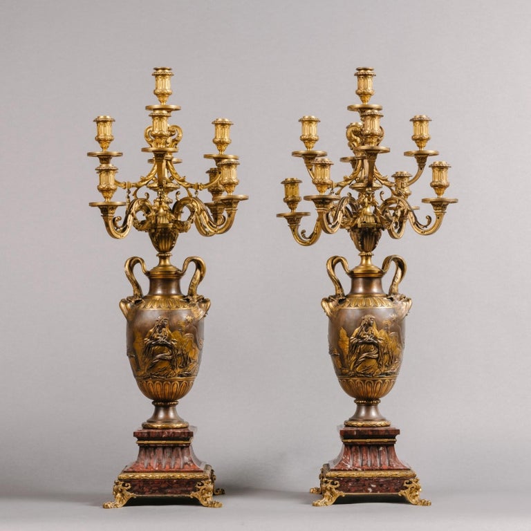 A fine pair of neoclassical style gilt and patinated bronze nine-light candelabra by Ferdinand Barbedienne,
French, Circa 1870.