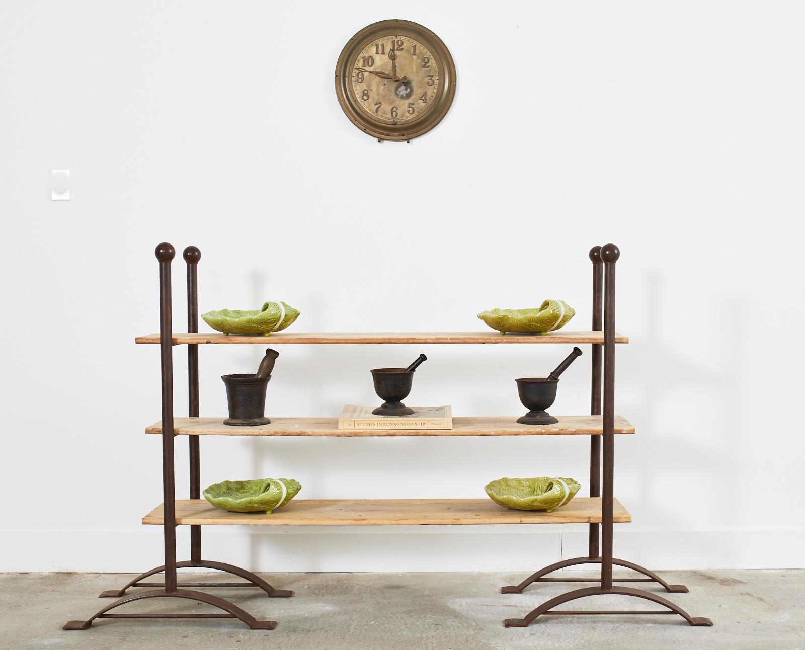 Artisan crafted pair iron and pine bakers racks, bookshelves, or display shelves. Beautifully crafted with an intentionally patinated finish on the iron and a bleached, aged finish on the pine planks. The thick iron columns feature large ball