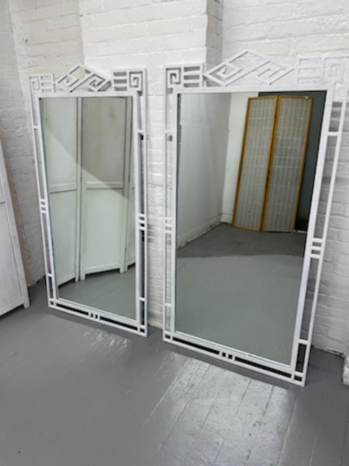 Pair of Hollywood Regency wrought iron decorative mirrors.